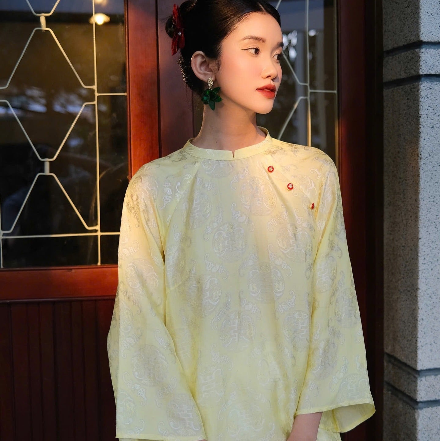 "Tra My Mandarin-neck top in light yellow woven silk, modern pattern, cultural authenticity"