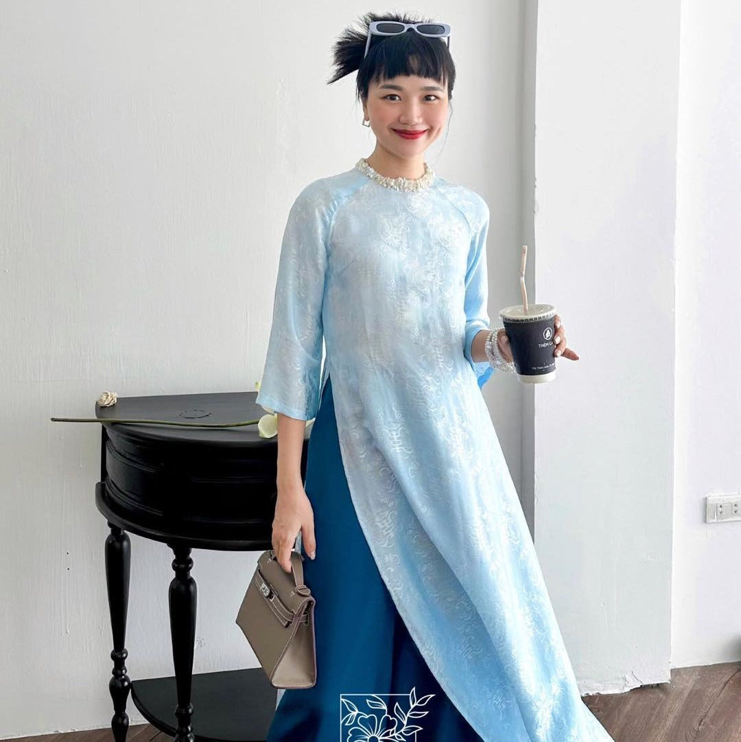 "Lam Ngoc blue silk Ao Dai set with sequined neck, modern Vietnamese design by Huyen Collection."
