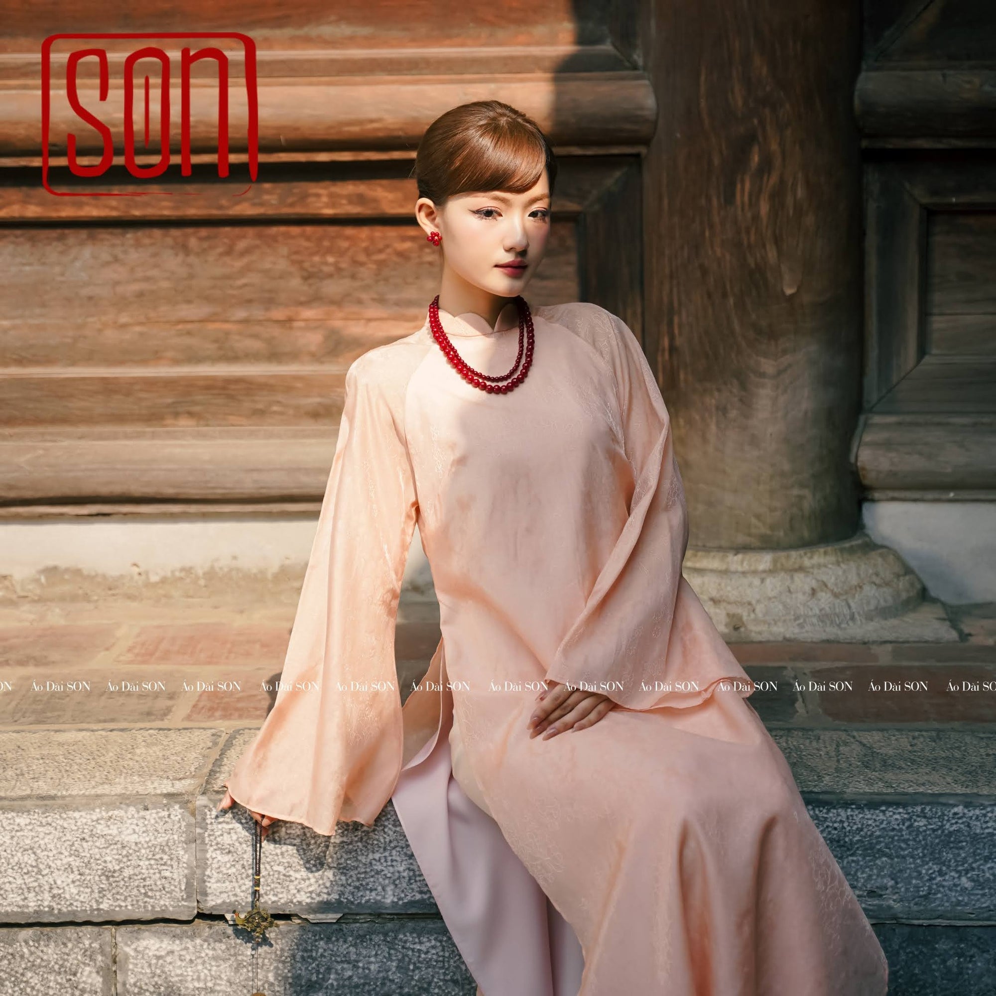 "Thy Son Ao Dai set in blush pink silk jacquard with floral pattern, traditional Vietnamese dress."