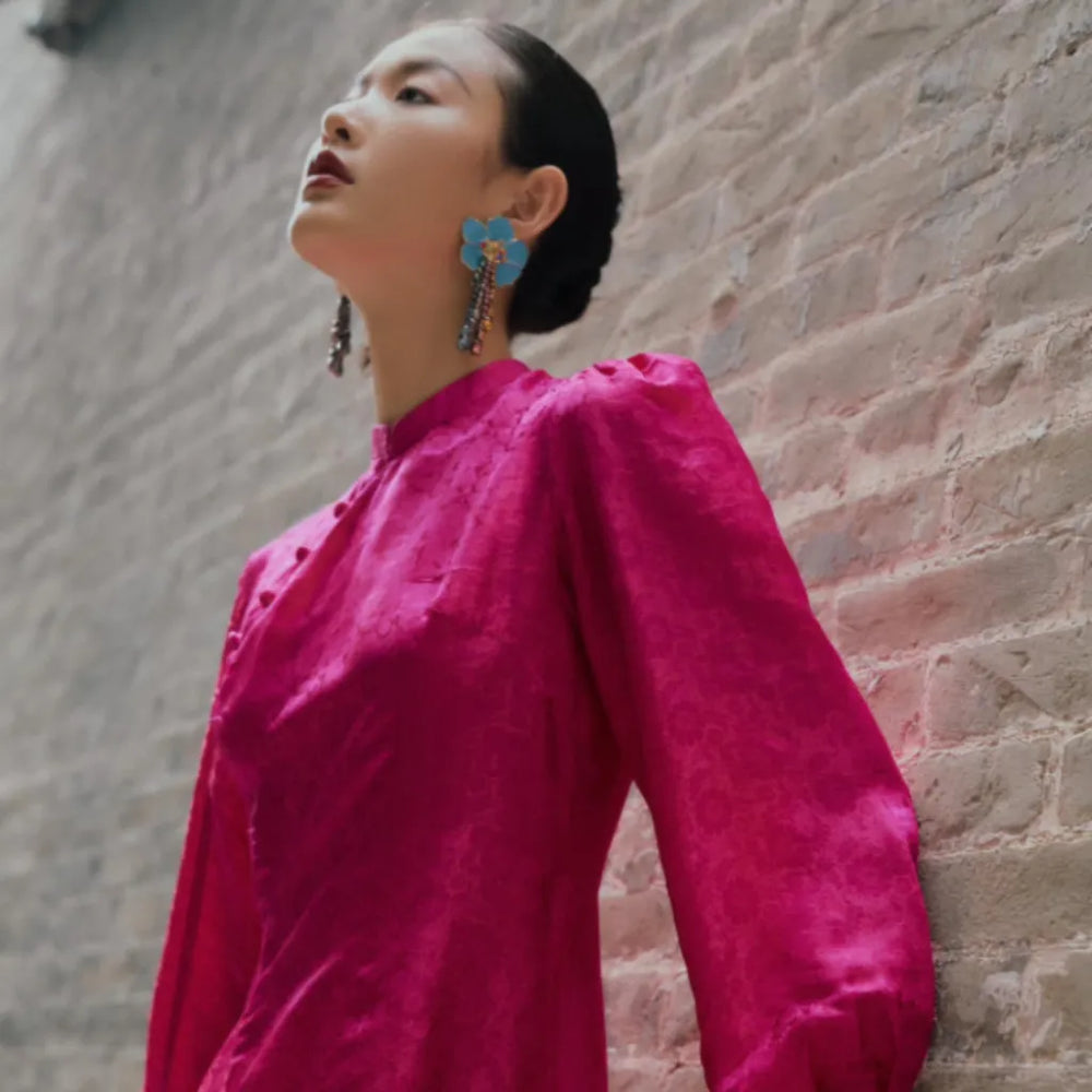 Banner image for the "Orient inspired Fashion" section of the website (Desktop). a girl wearing a magenta Ao dai