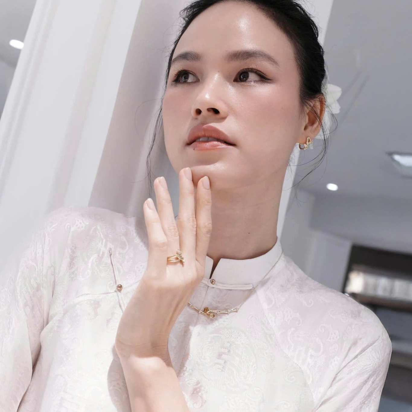 "Hy Loan Ao Dai Set in white silk by Lalin, traditional Vietnamese dress with modern patterns."