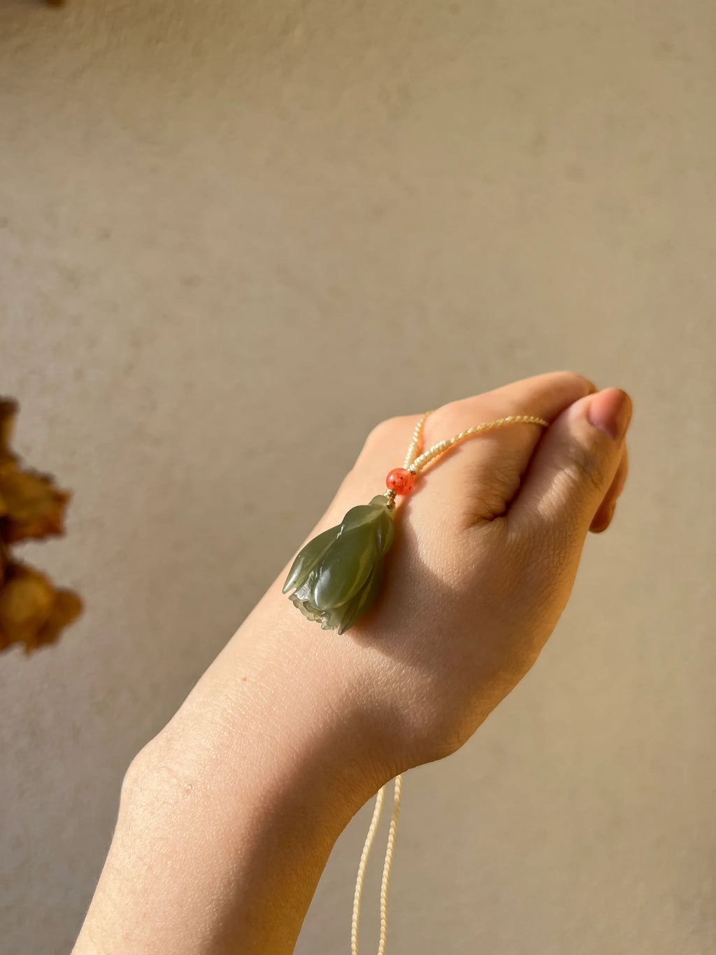 “Magnolia Dawn” - Hand Carved Light Green Hetian Jade Magnolia Pendant，手雕和田青黄口玉兰花 - detail close-up in green by L'Orient Haus