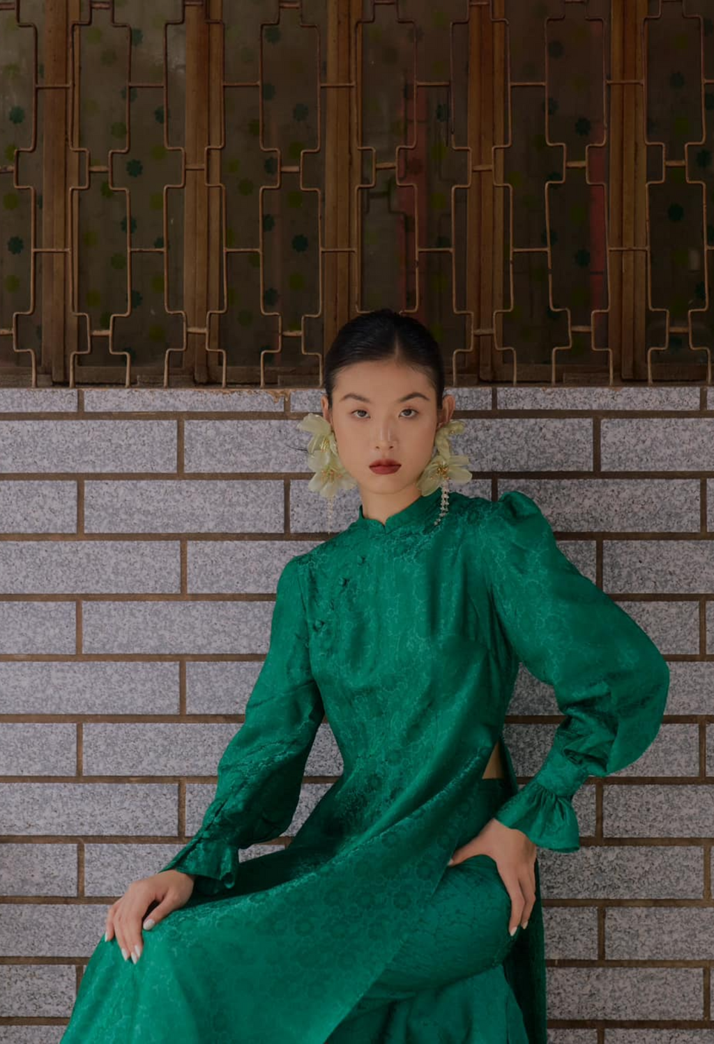 "Green silk Ao Dai set with puff sleeves, floral jacquard pattern, traditional Vietnamese design by SY Design."