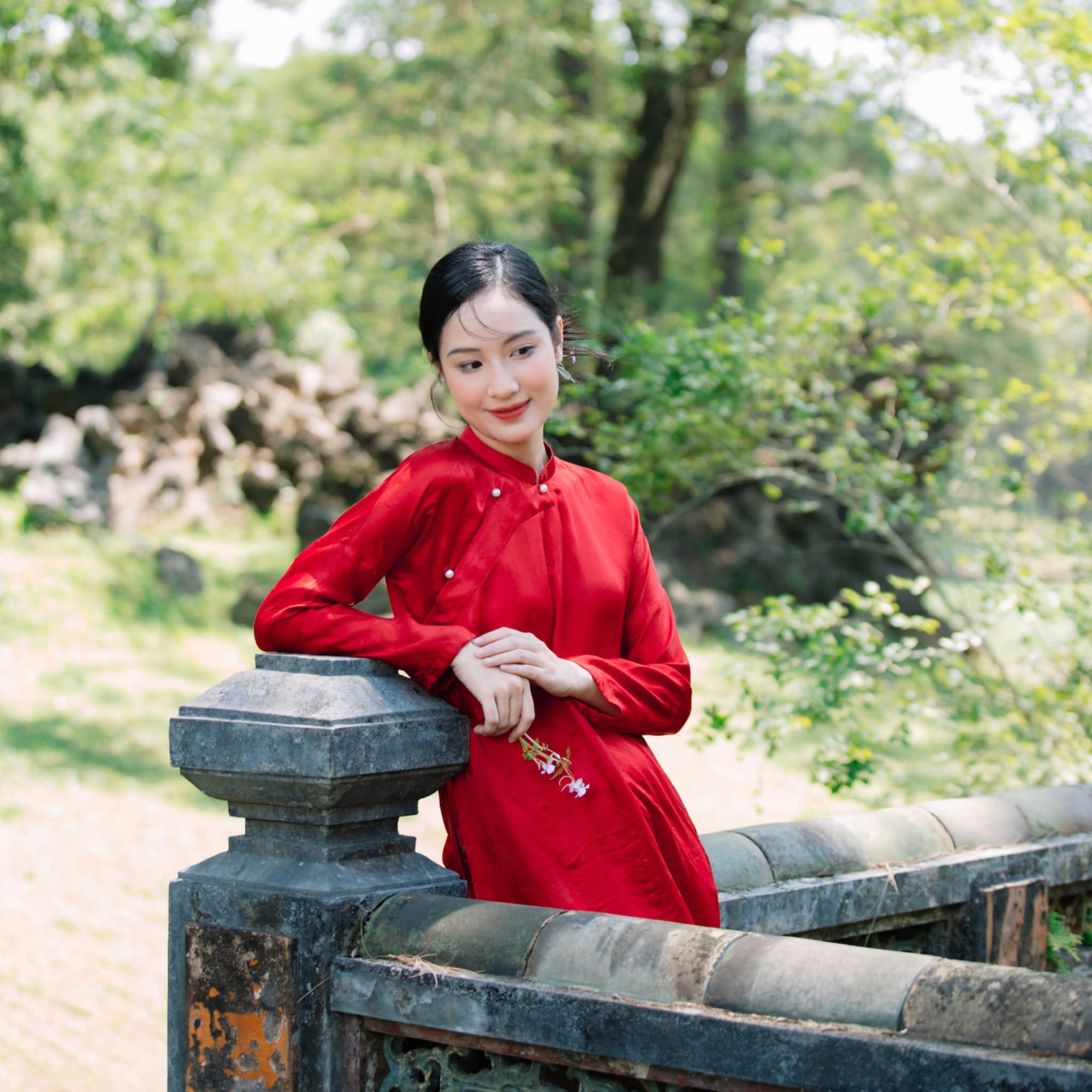 "Red Ngu Than Ao Dai set in silkworm silk by Moc, traditional Vietnamese dress."