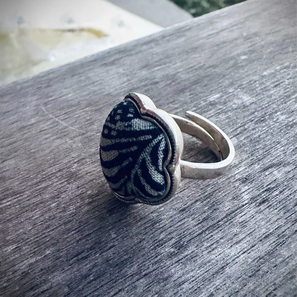 Noir Miao silver ring close-up showing intricate ethnic patterns
