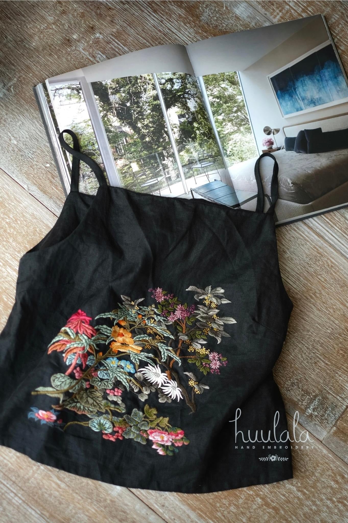 "Mai - Embroidered Linen Tank Top in black by Huulala, featuring vibrant floral patterns, Vietnamese-inspired design."