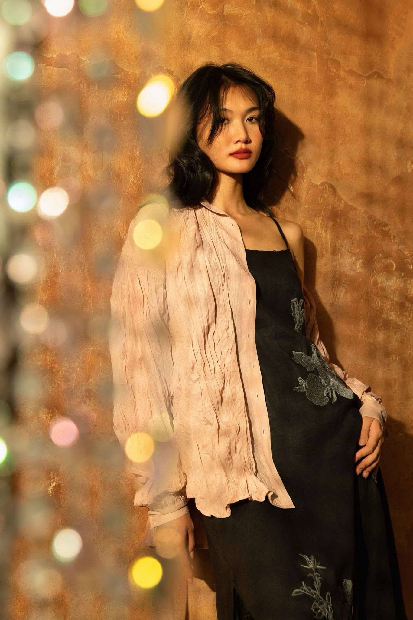 "Magnolia" embroidered linen slip dress in noir by Huulala, black with floral pattern.