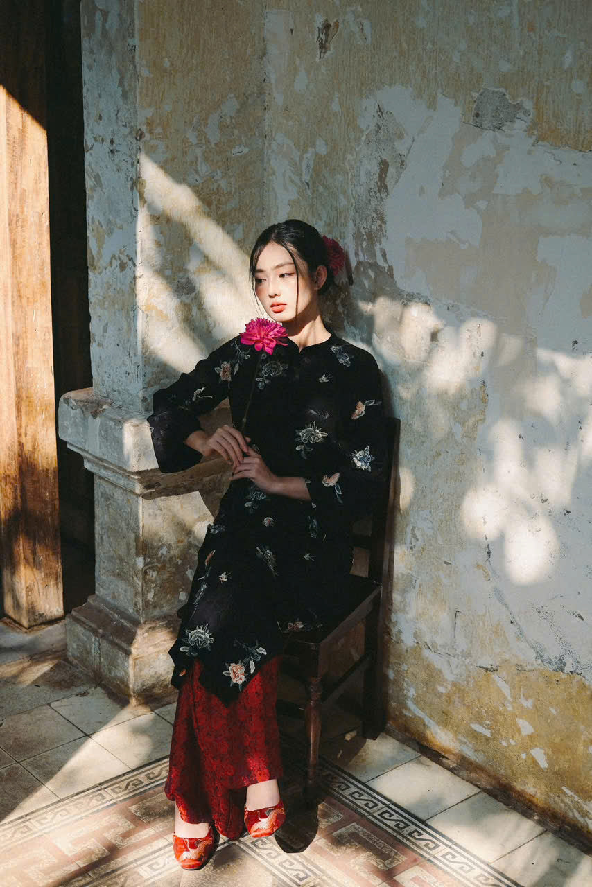 "Traditional Vietnamese Ao dai set in black viscose with floral embroidery, featuring red silk pants."