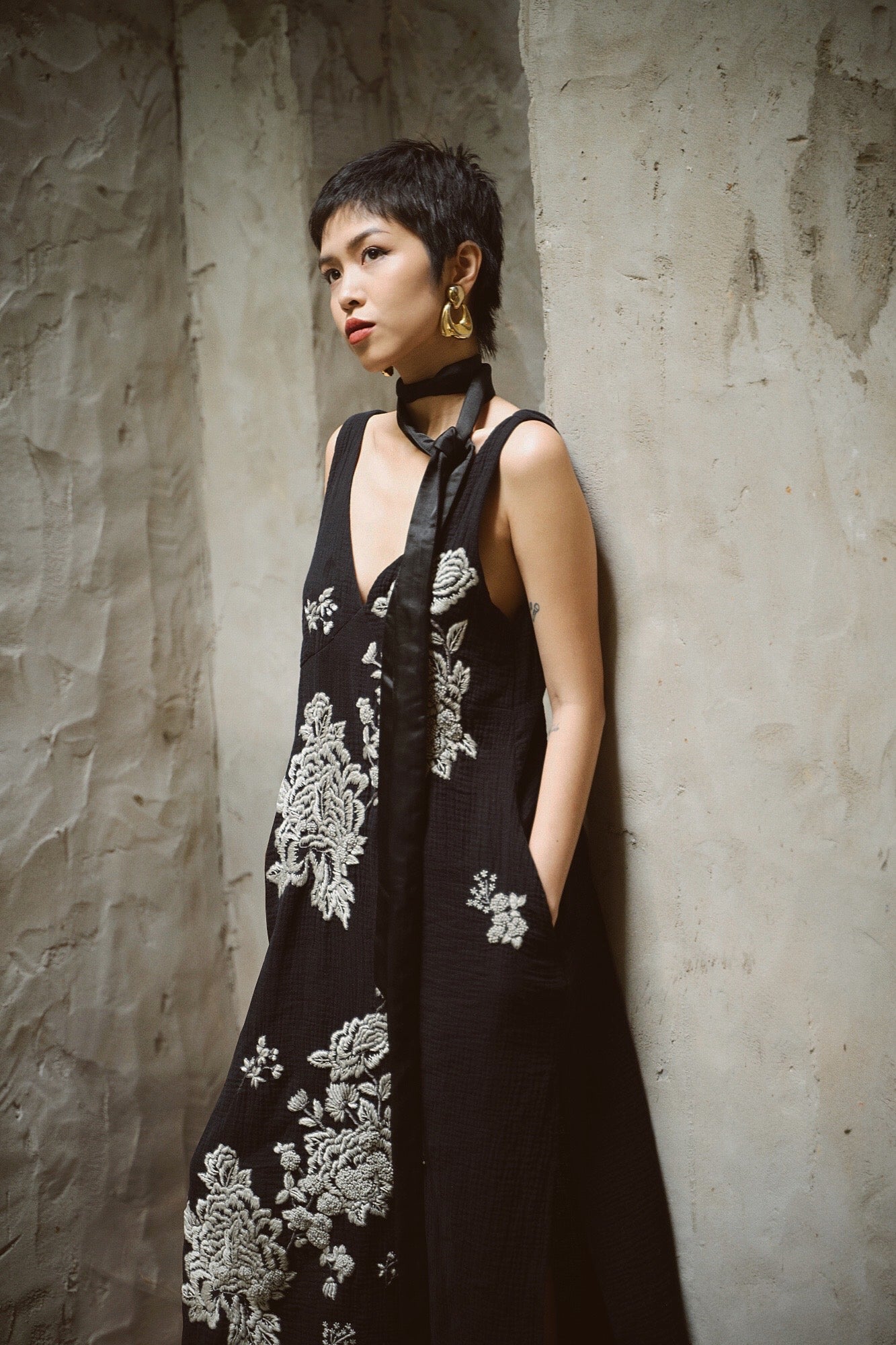 "Night Bloom" embroidered V-neck muslin dress in black with floral pattern, by Huulala, showcasing Vietnamese artisan craftsmanship.