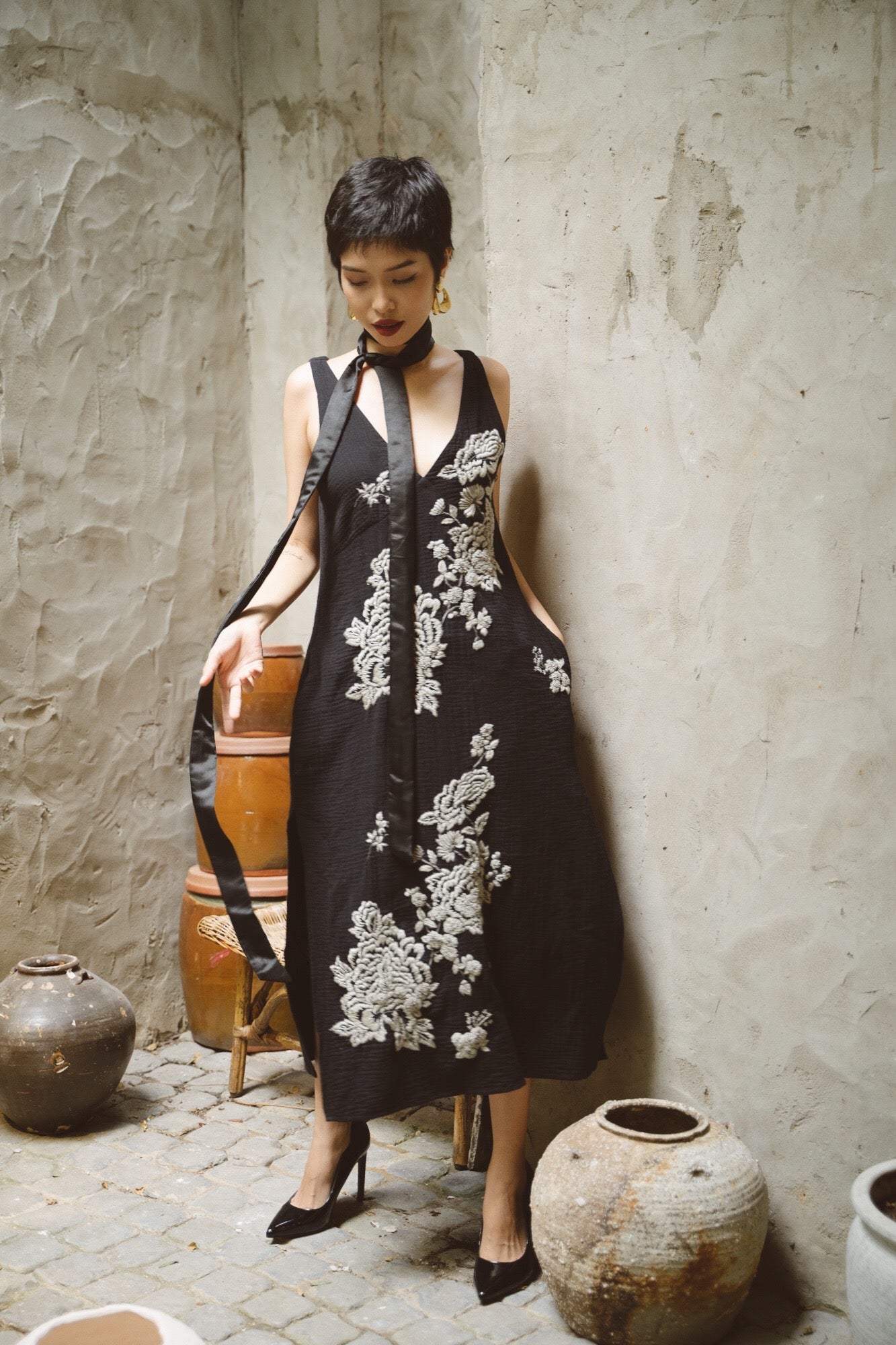 "Night Bloom" - Black embroidered V-neck muslin dress by Huulala, featuring artisan floral patterns, Vietnamese cultural design.