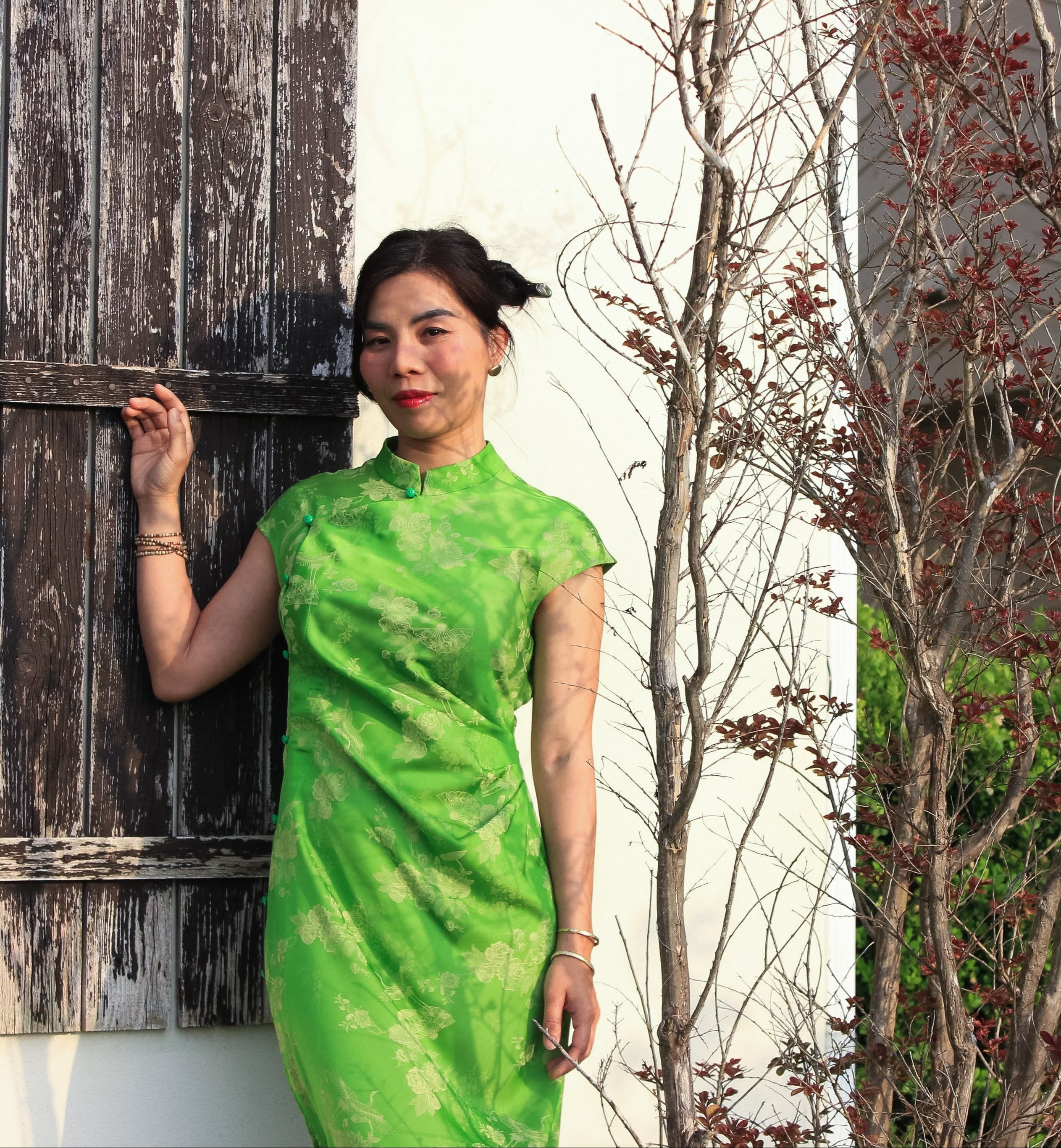 "Sleeveless green cheongsam top in silk jacquard weave, modern Vietnamese design"