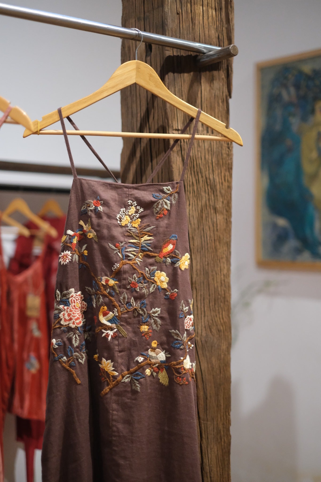 "Song bird" - Embroidered Linen Dress in Beige by Huulala, featuring artisan floral embroidery and red accents.