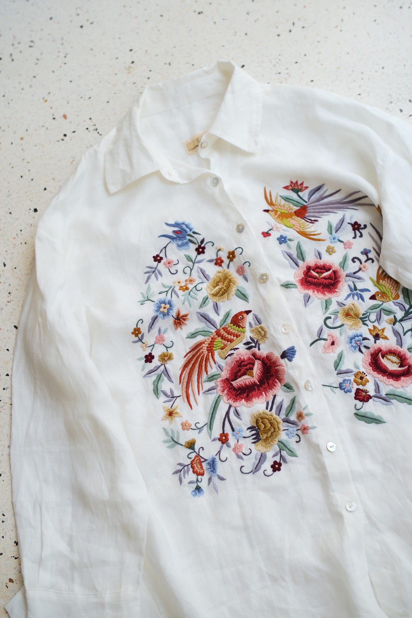 "Zoya embroidered linen shirt in white with pink floral design, Vietnamese-inspired by Huulala"