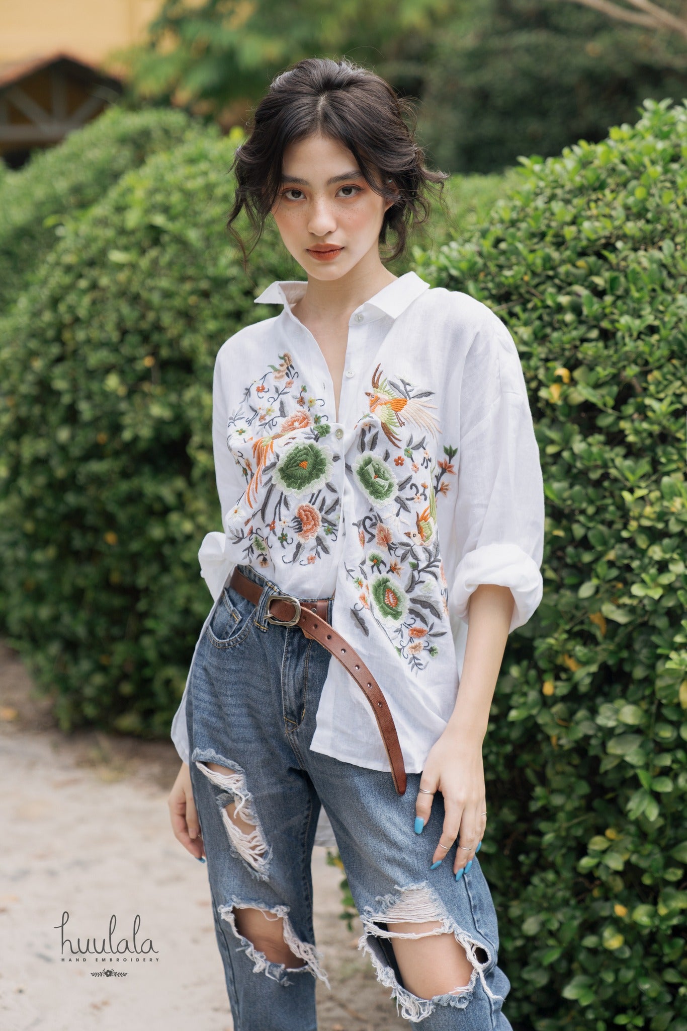 "Zoya embroidered linen shirt by Huulala in white with pink floral design, Vietnamese-inspired fashion."