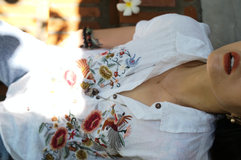 "Zoya embroidered linen shirt in white with pink floral design, Vietnamese cultural style by Huulala."