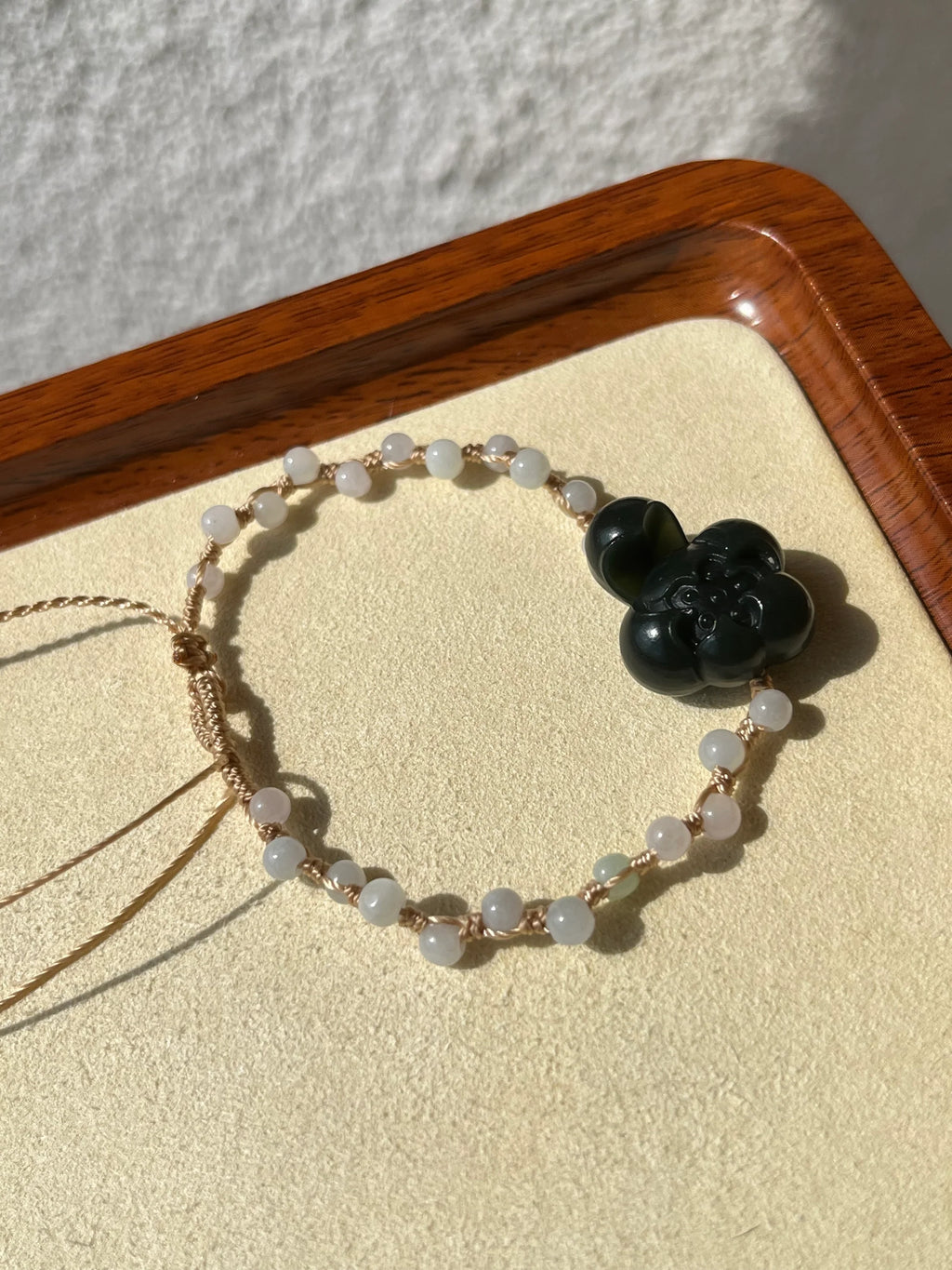 Lotus Noir - Handmade Bracelet with a Dark Cyan Hetian Jade Lotus | 手编和田青玉一细小荷花手牌 - flat lay display by L'Orient Haus