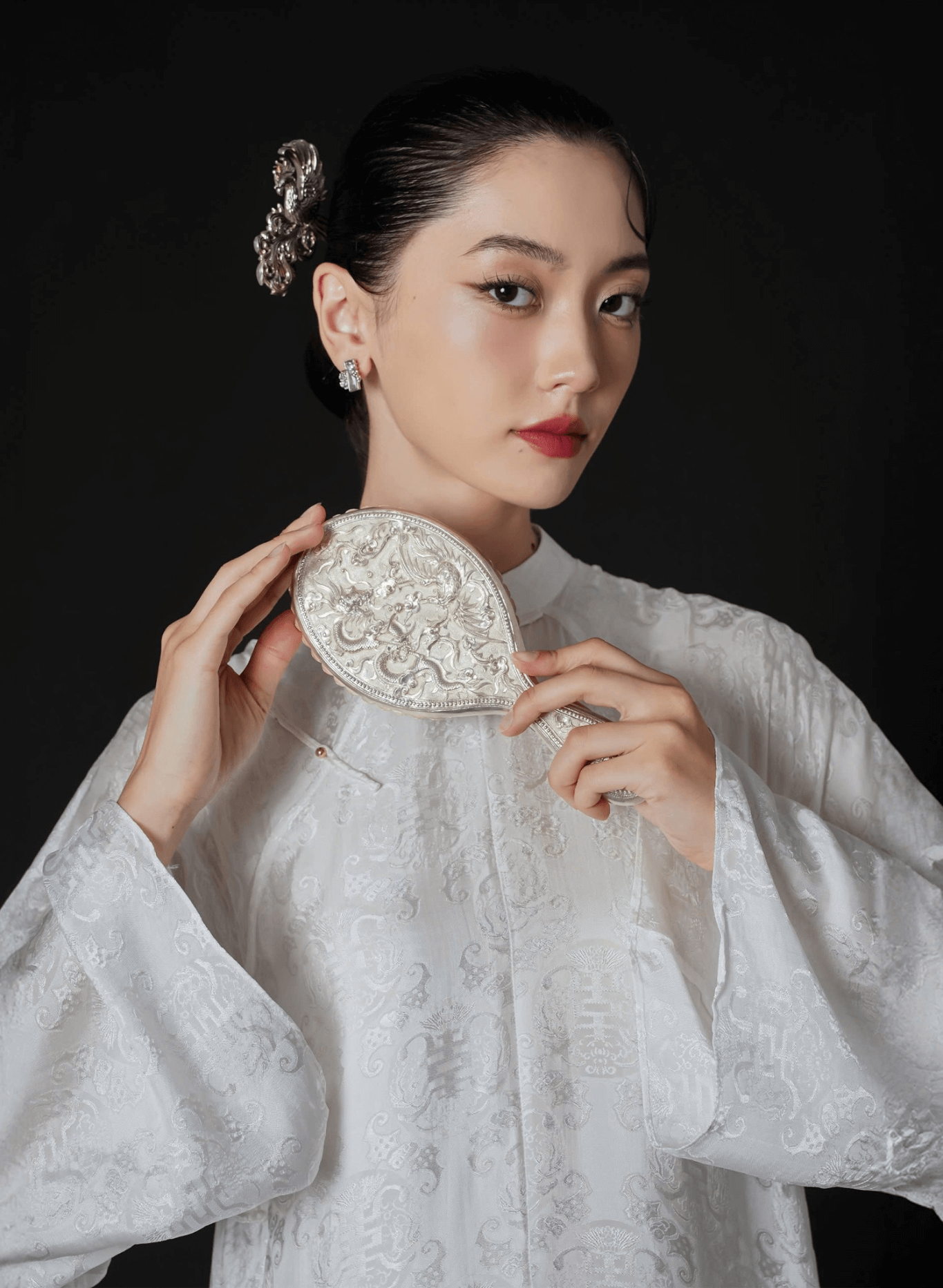 "Hy Loan Ao Dai Set in white silk by Lalin, featuring traditional Vietnamese patterns and artisan design."