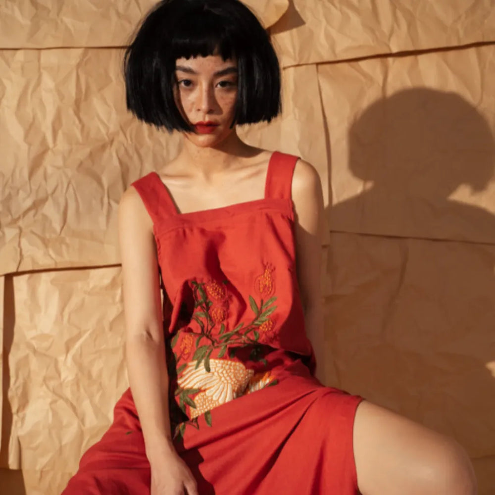 Banner image for the "Hand Embroidery " section of the website (Mobile). a  girl wearing a linen dress with  embroidery 