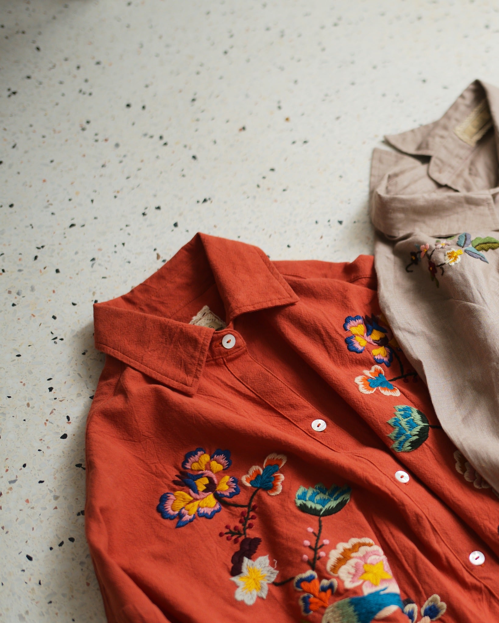"Huulala's 'Sophie' Vietnamese embroidered linen shirt in orange with floral patterns"