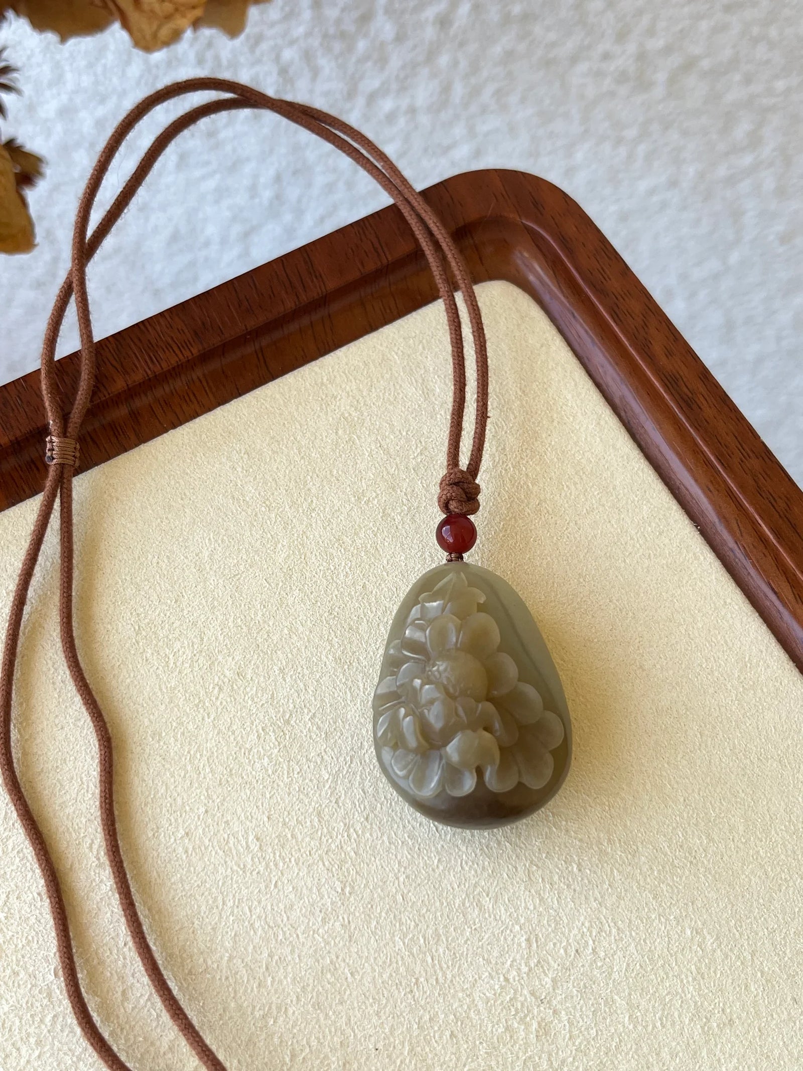 “Amber Peony” - Brown Hetian Jade Peony Flower Pendant - flat lay display in white by L'Orient Haus