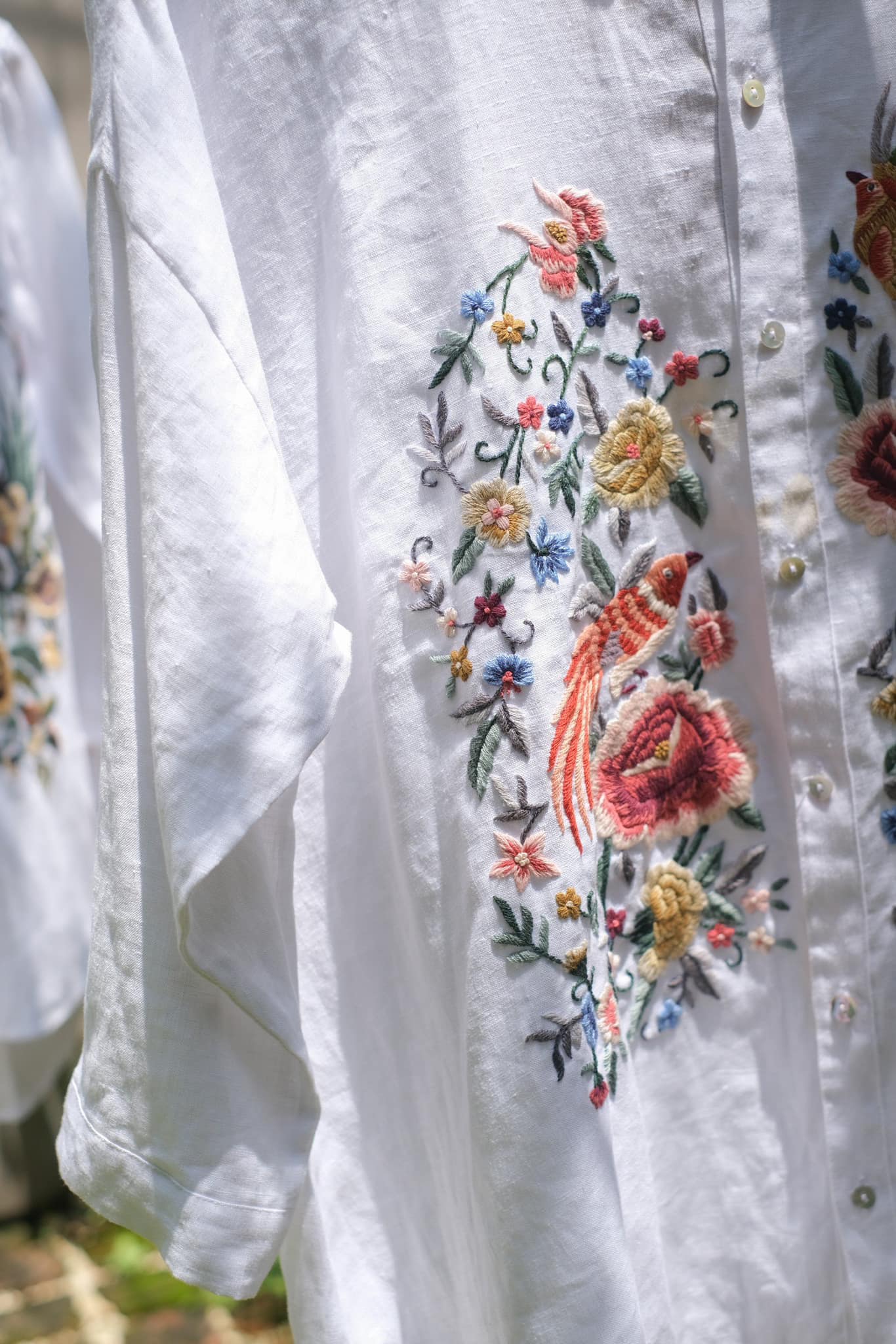 "Zoya embroidered linen shirt in white with pink floral design, Vietnamese-inspired by Huulala"