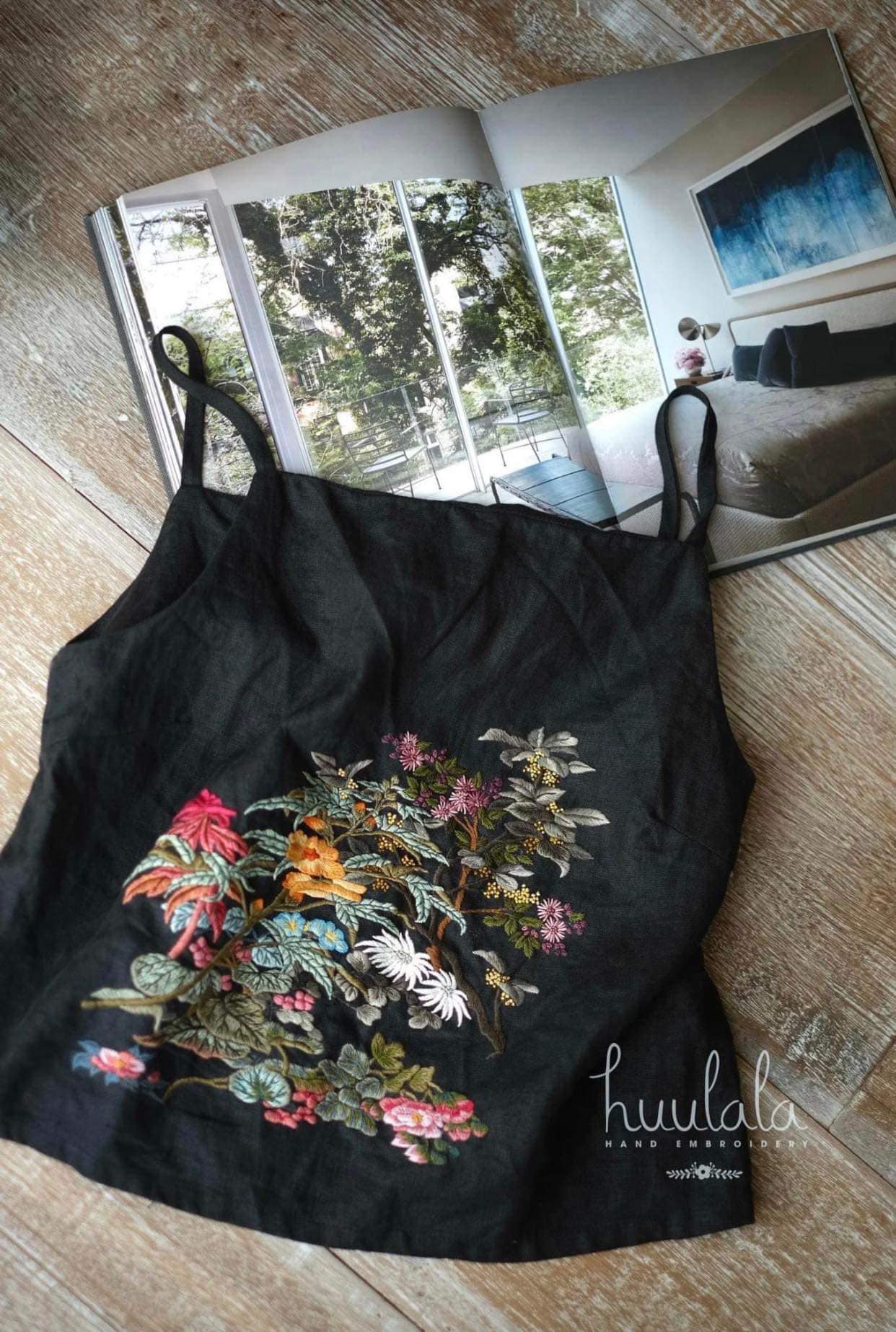 "Minh hand-embroidered Vietnamese linen tank top by Huulala in black with vibrant floral silk patterns."