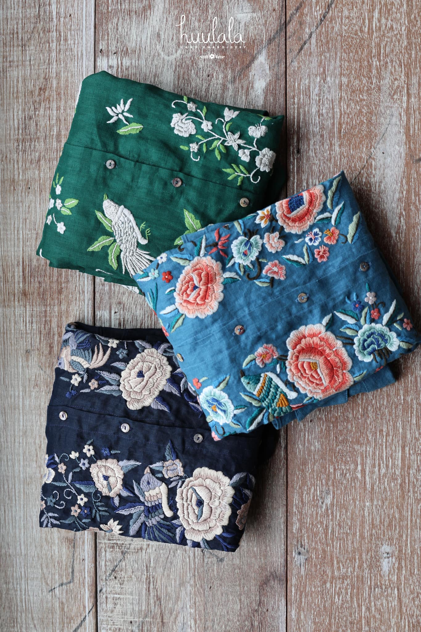 "Zoya Limited Edition Embroidered Linen Shirt in Teal by Huulala, featuring Vietnamese floral patterns in red and blue."
