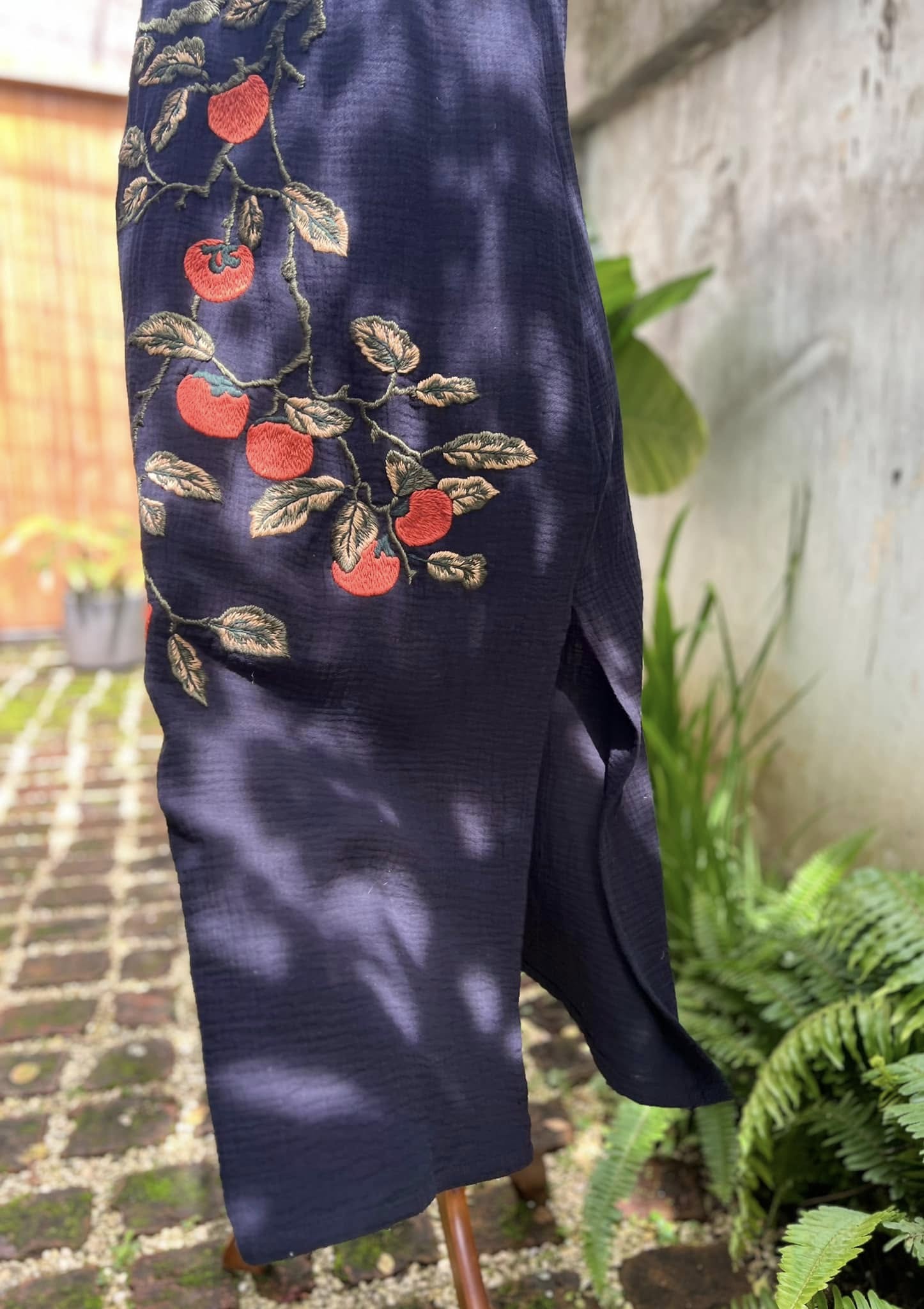 "Persimmon" embroidered black muslin dress by Huulala, featuring red artisan patterns, Vietnamese cultural design.