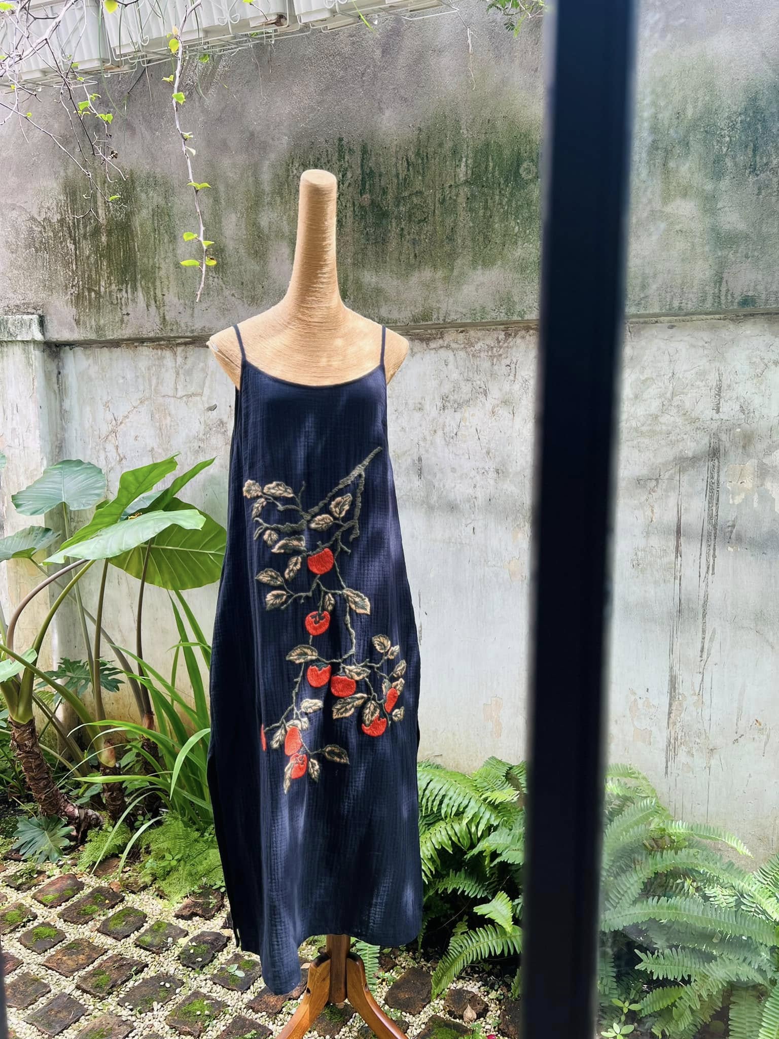 "Persimmon" embroidered muslin dress in black by Huulala, featuring red artisan Vietnamese floral design.
