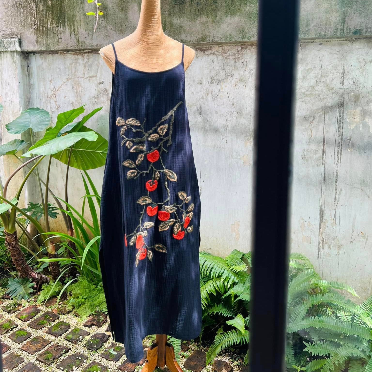 "Persimmon" embroidered muslin dress in black by Huulala, featuring red artisan Vietnamese floral design.