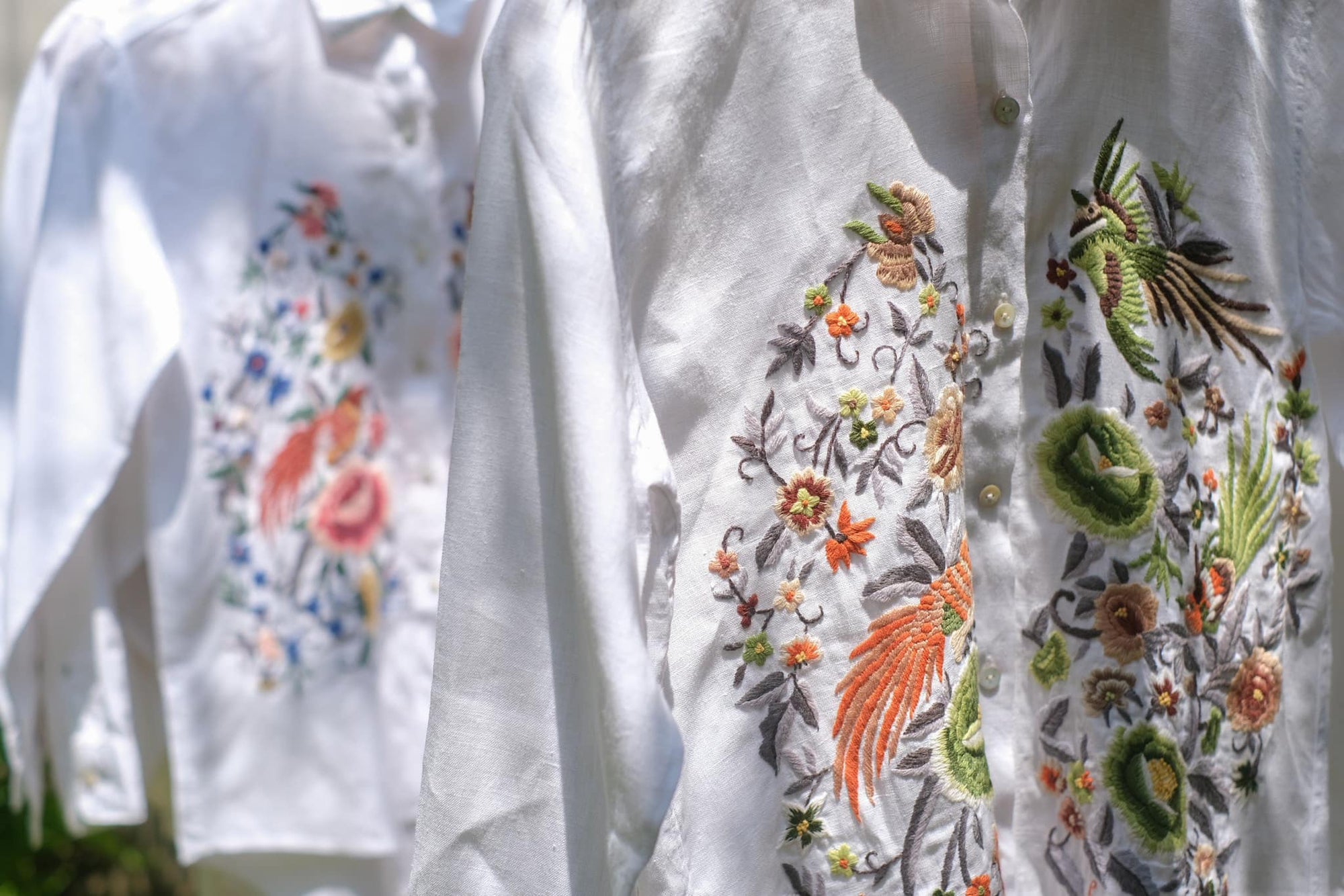 "Zoya embroidered linen shirt in white with pink floral design, Vietnamese-inspired, by Huulala."