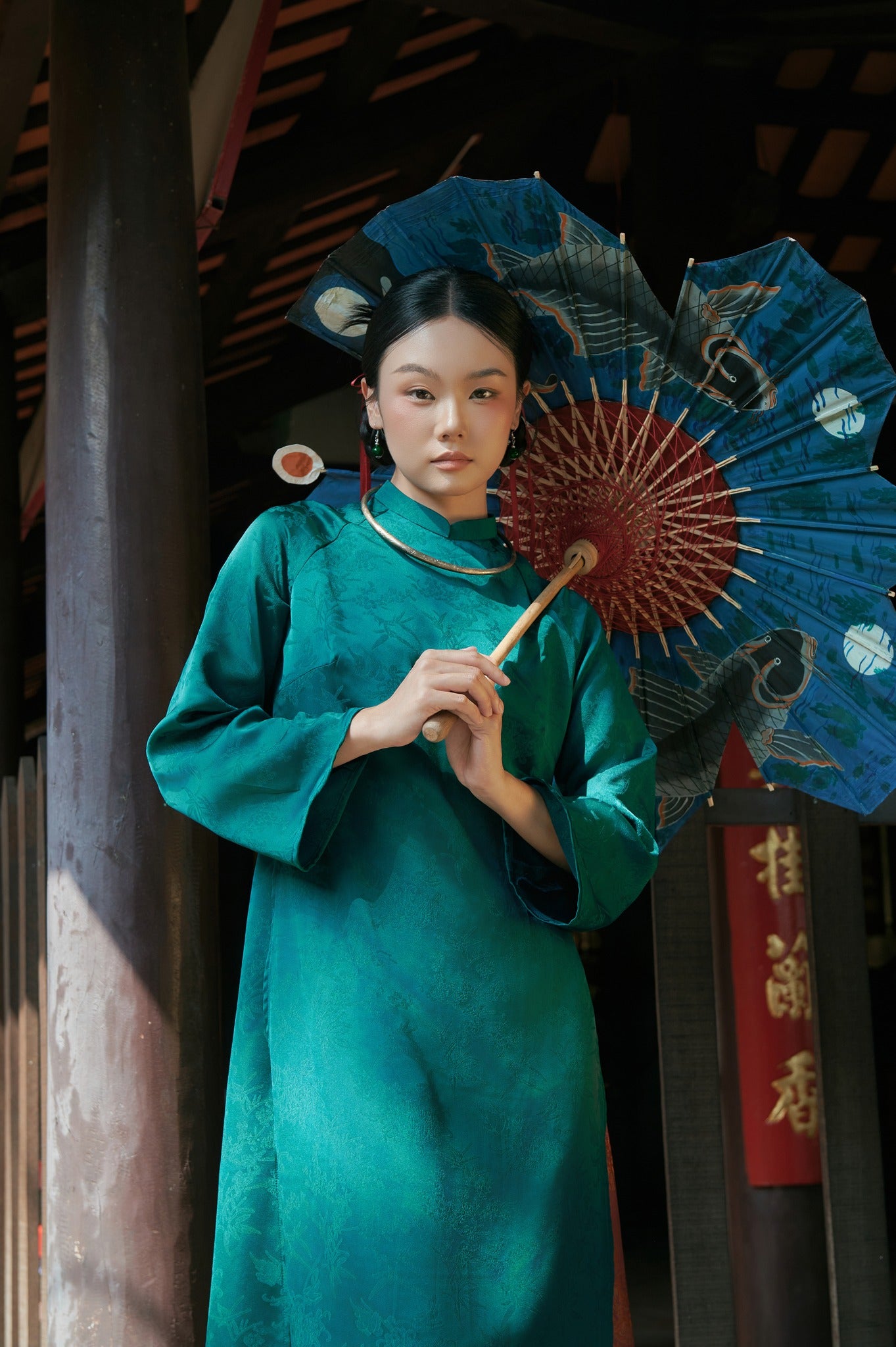 "Truc Khue Ao Dai set in Peacock, traditional Vietnamese dress in red jacquard with artisan design."