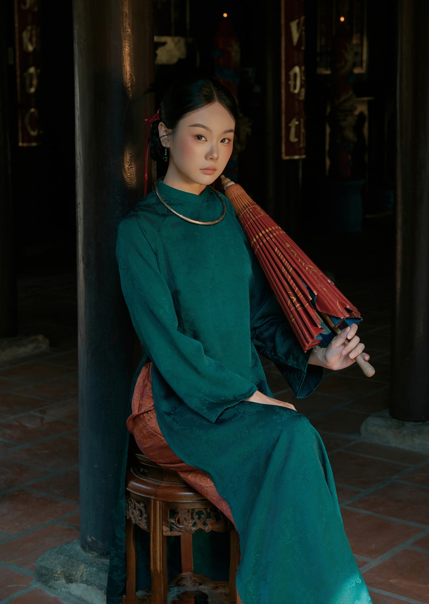 "Truc Khue Ao Dai set in Peacock by Moc, traditional Vietnamese dress in red jacquard with artisan design."