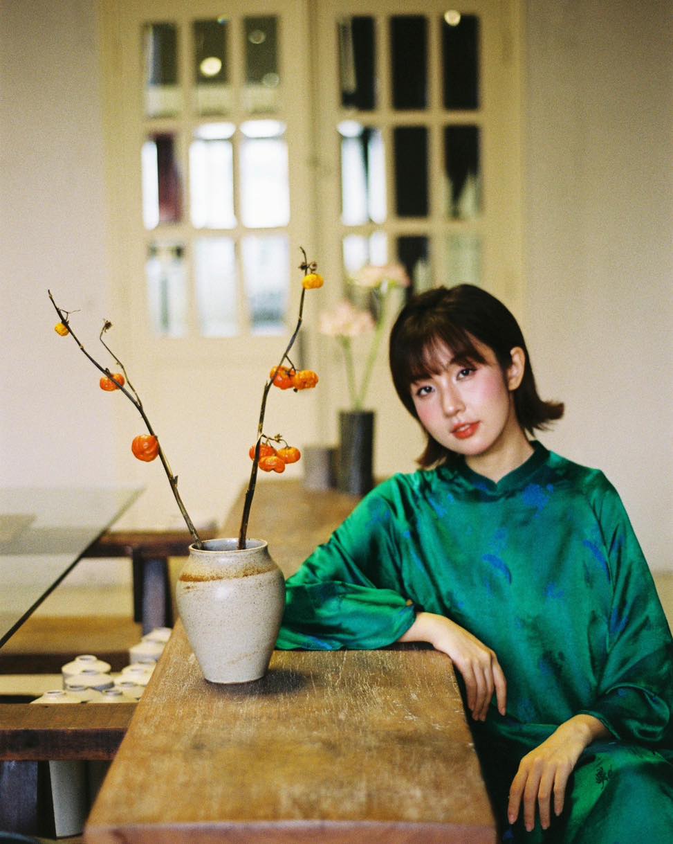 "Green silkworm silk Ao dai set by Moc, traditional Vietnamese dress with modern pattern."