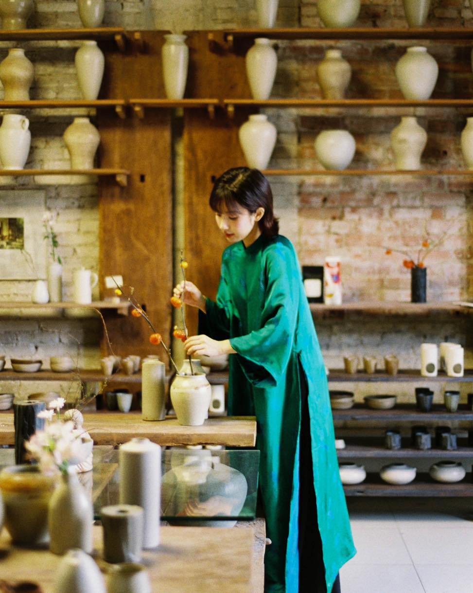 "Green silkworm silk Ao dai set by Moc, traditional Vietnamese dress with modern artisan design."