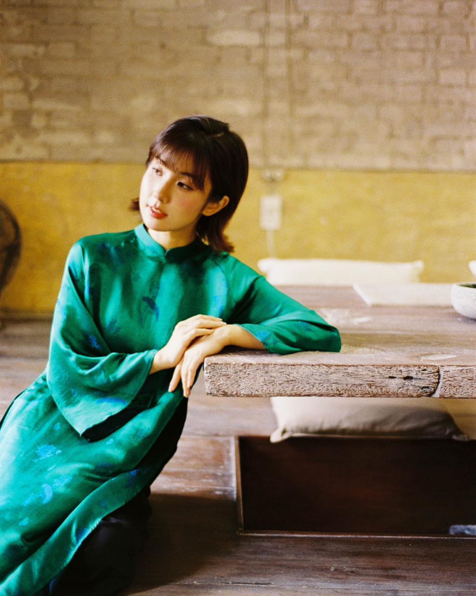 "Green silk 'Lien Hoa' Ao Dai set by Moc, traditional Vietnamese dress with modern pattern."