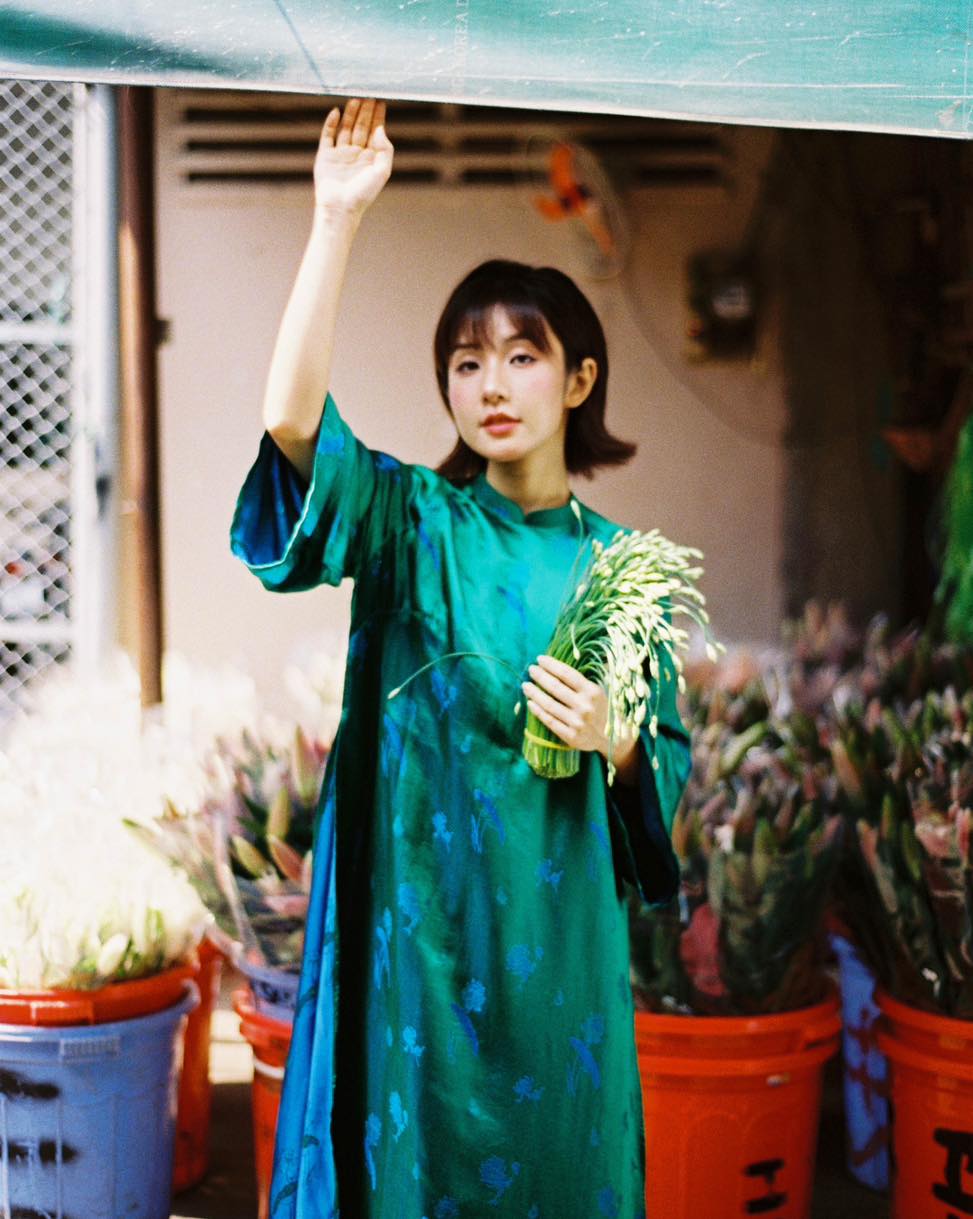 "Green silk 'Lien Hoa' Ao Dai set by Moc, traditional Vietnamese dress with modern pattern."