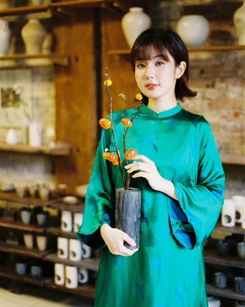 "Green silk 'Lien Hoa' Ao Dai set by Moc, traditional Vietnamese dress with modern artisan design."