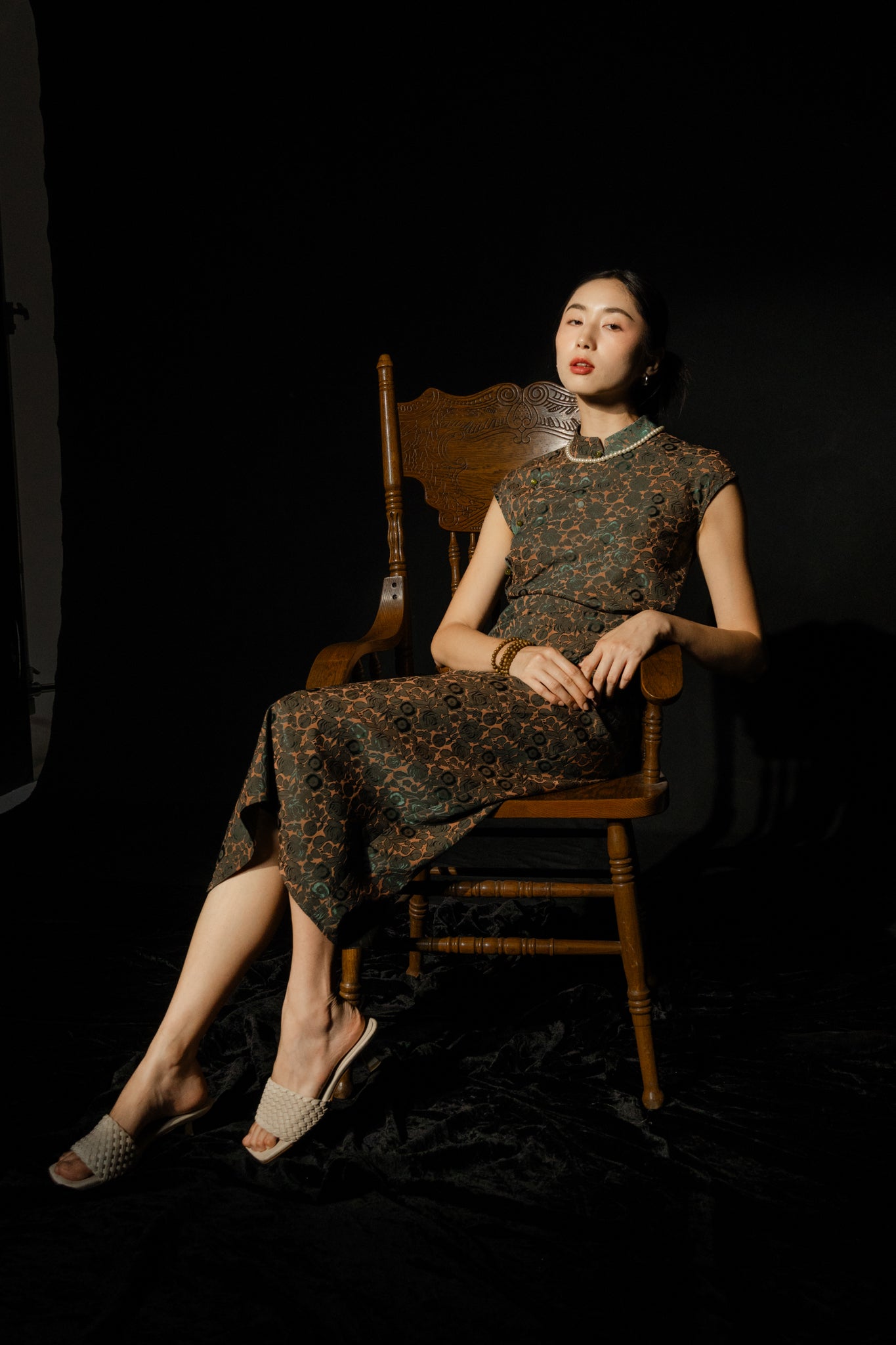 "Hương Trầm sleeveless cheongsam in black jacquard silk, modern Vietnamese design by Hy Phuong"