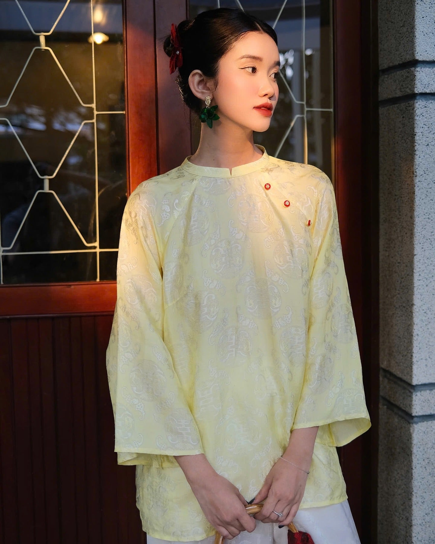 "Tra My Mandarin-neck top in light yellow woven silk, modern pattern, cultural authenticity"
