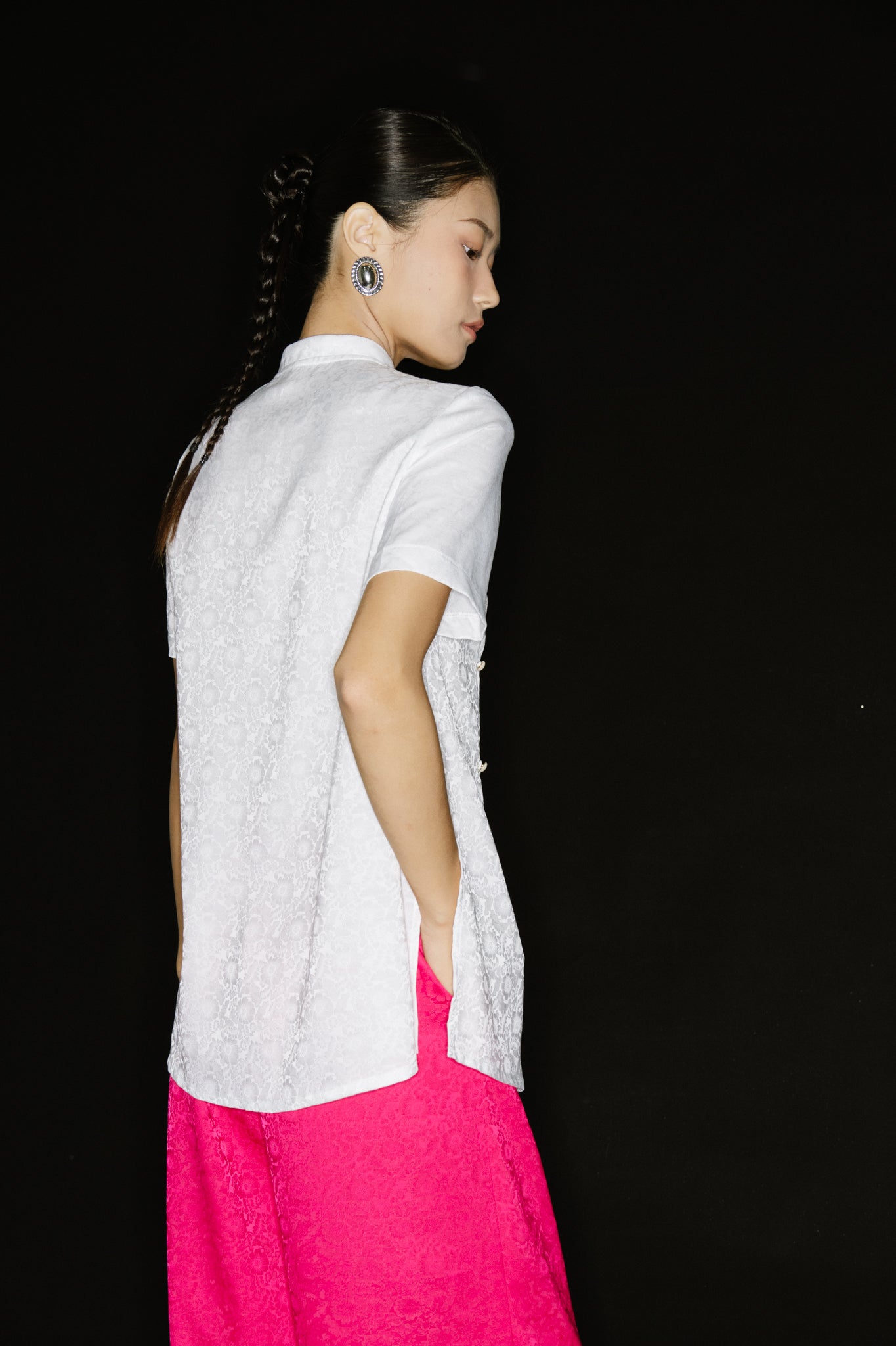 "Vietnamese 'Tinh Duyen' Mandarin silk top in white with floral jacquard, paired with fuchsia wide-leg pants by Hy Phuong."