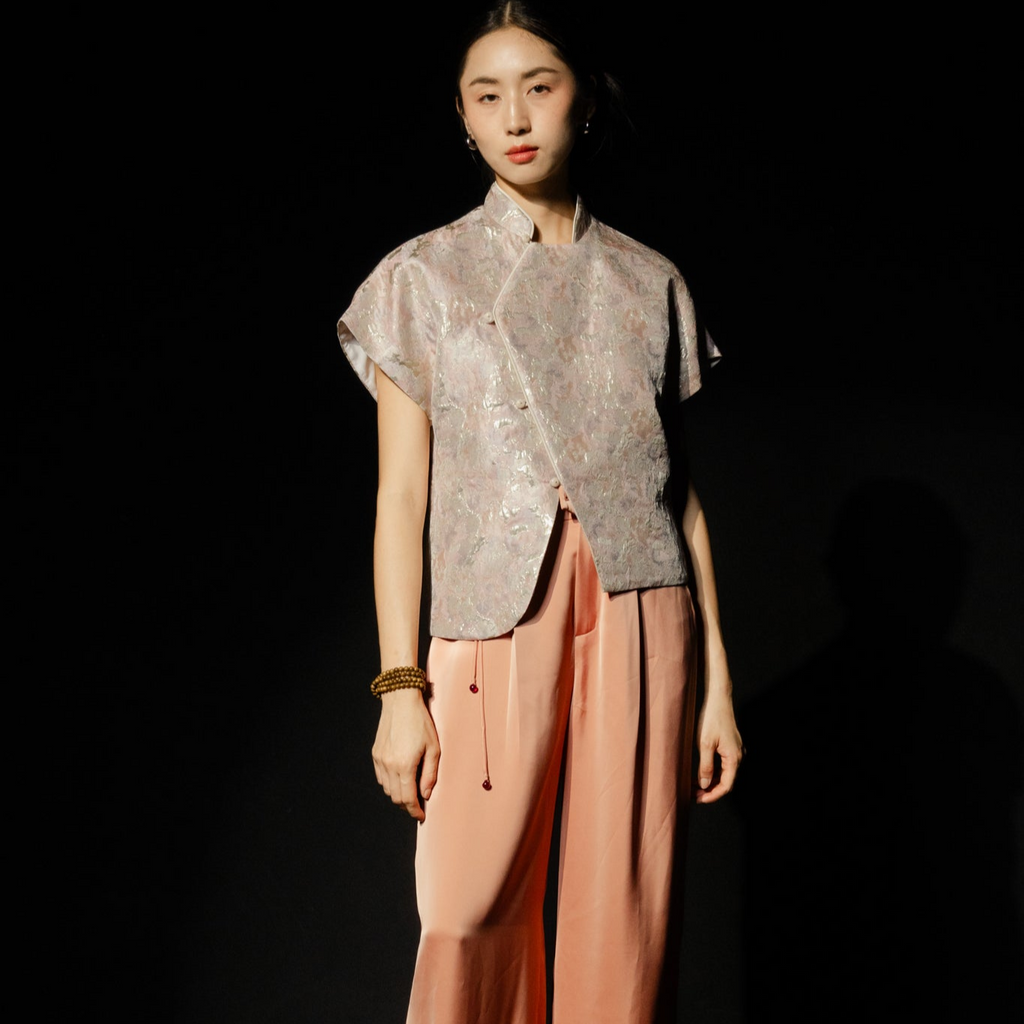 "Traditional Vietnamese Nghinh Xuan set with pleated peach orange silk pants and tassel, by Hy Phuong."