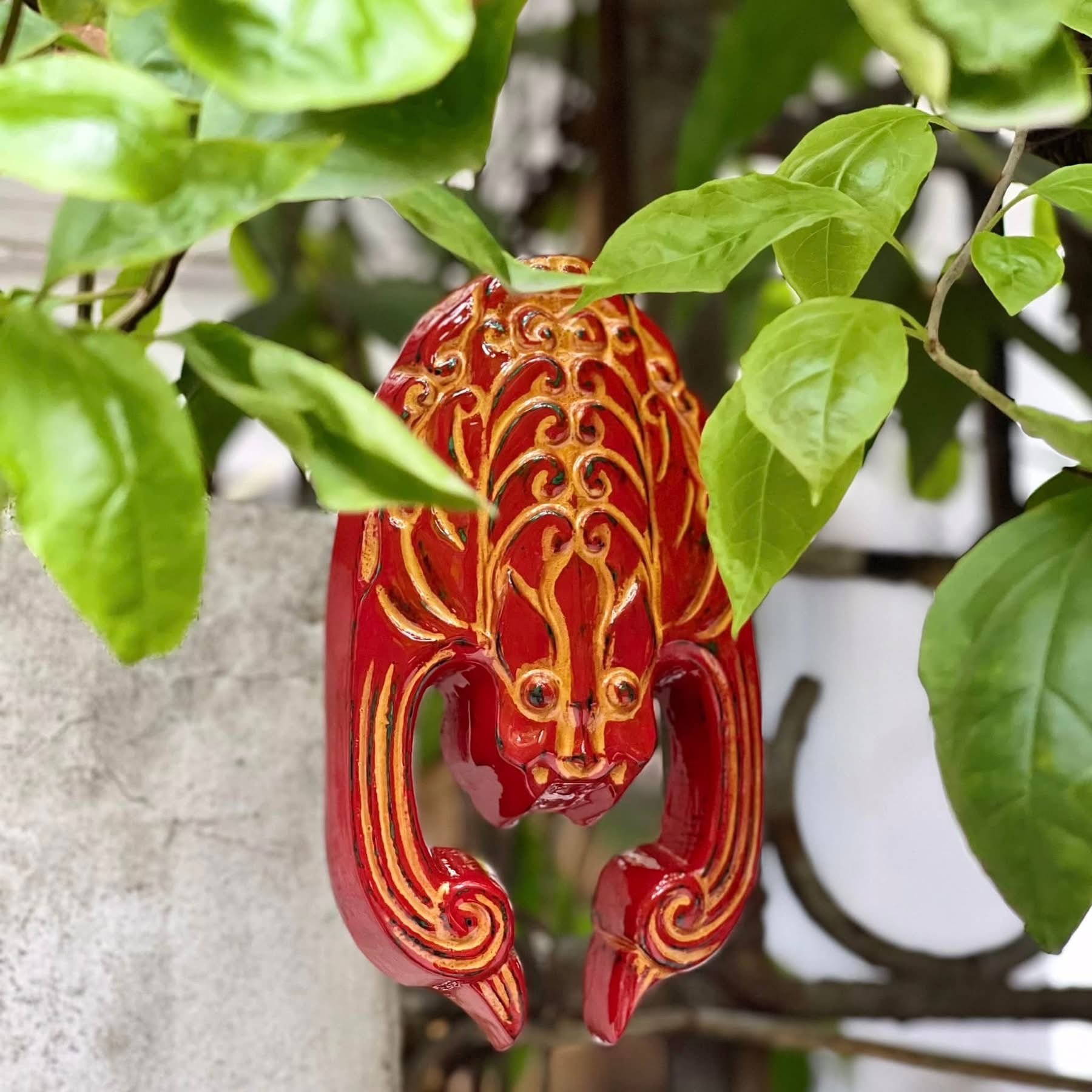 "Phuc Dao Tien Mon" Vietnamese artisan door charm in red with traditional patterns.