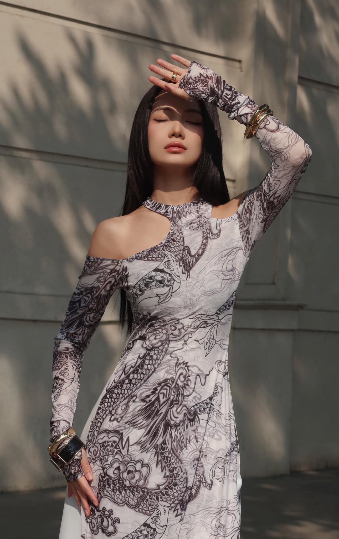 "Jia Chen Tulle Ao Dai Set in black with intricate dragon pattern, traditional Vietnamese dress by Keira Tong"