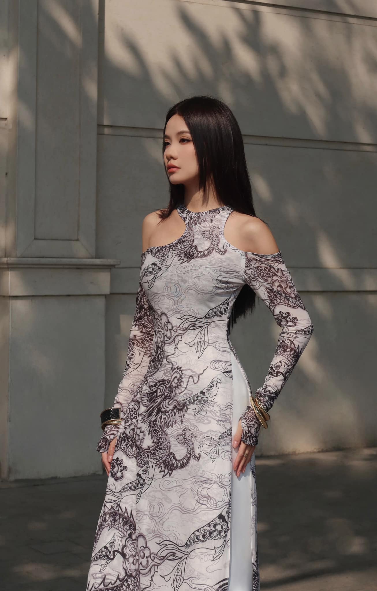 "Jia Chen Tulle Ao Dai Set in Black by Keira Tong, traditional Vietnamese dress with modern dragon pattern."