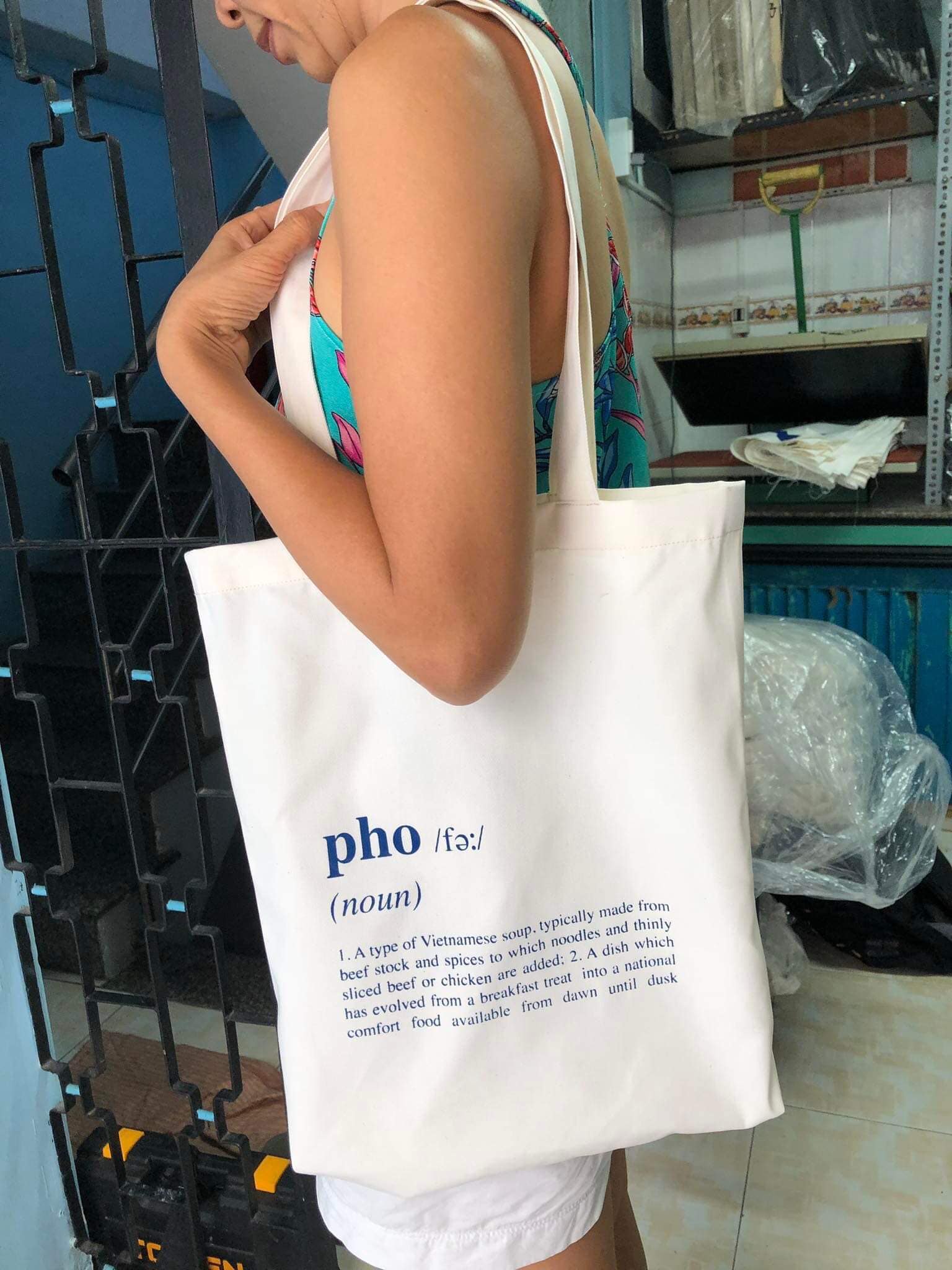 "Un-Pho-gettable Kitchen Towel by Bat-trang, featuring traditional Vietnamese design with pho definition print on white fabric."