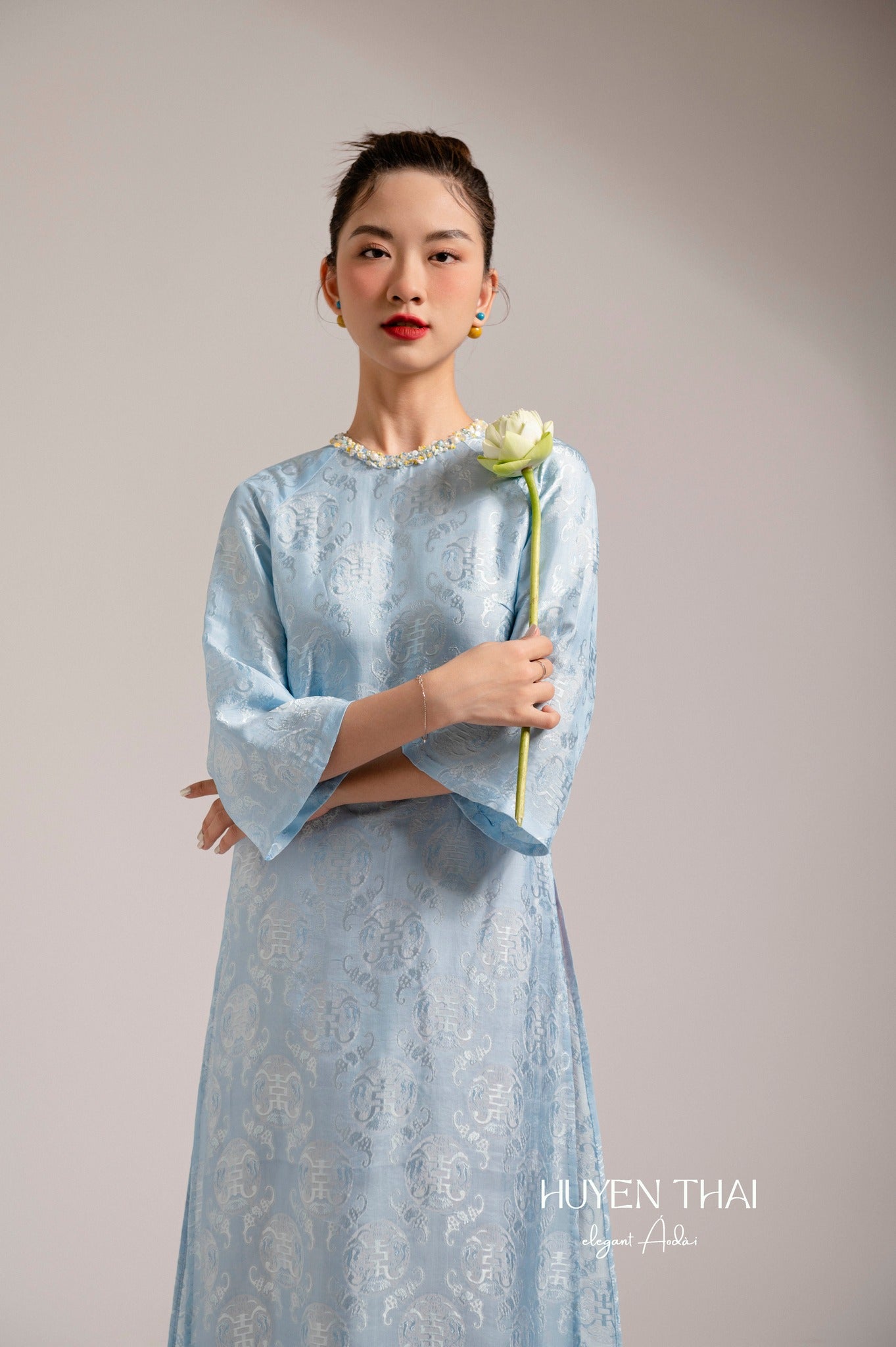 "Lam Ngoc blue silk Ao Dai with sequined neck, traditional Vietnamese dress by Huyen Collection"