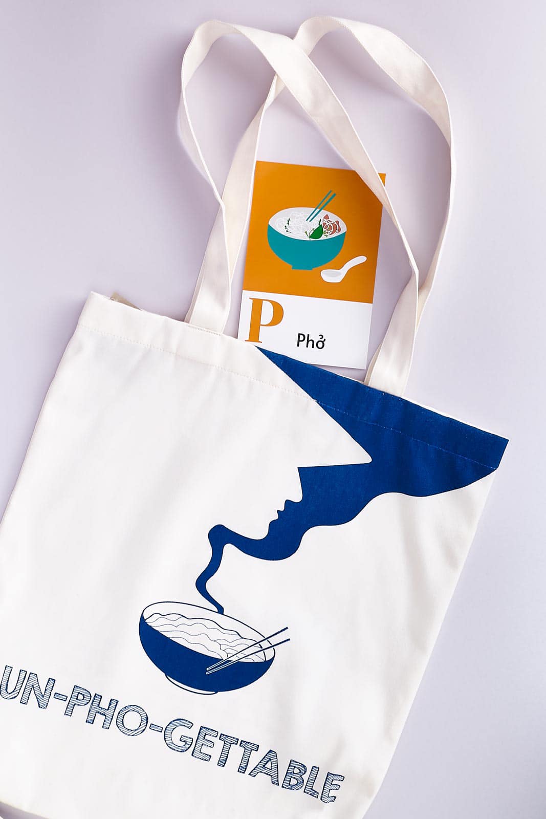 "Un-Pho-gettable Tote Bag by Bat-trang, white with blue traditional Vietnamese pho design"