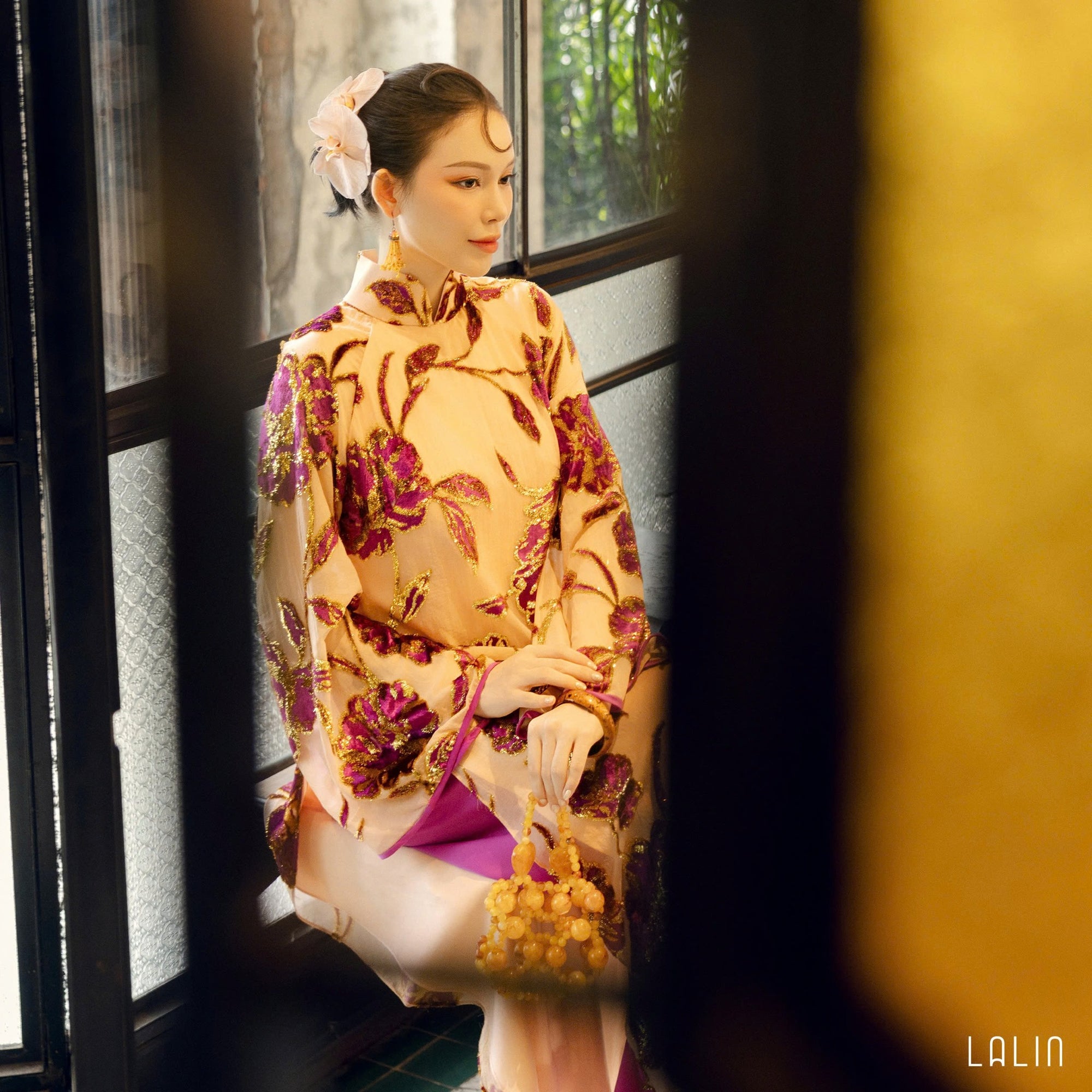 "Traditional Vietnamese Ao dai in violet sequin satin with floral embroidery by Lalin."
