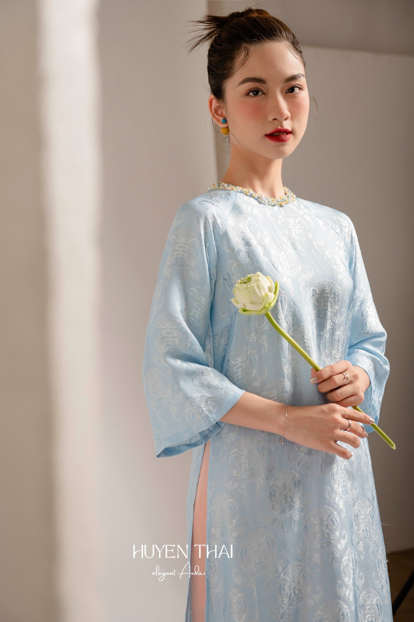 "Lam Ngoc blue silk Ao Dai set with sequined neck, traditional Vietnamese dress by Huyen Collection."